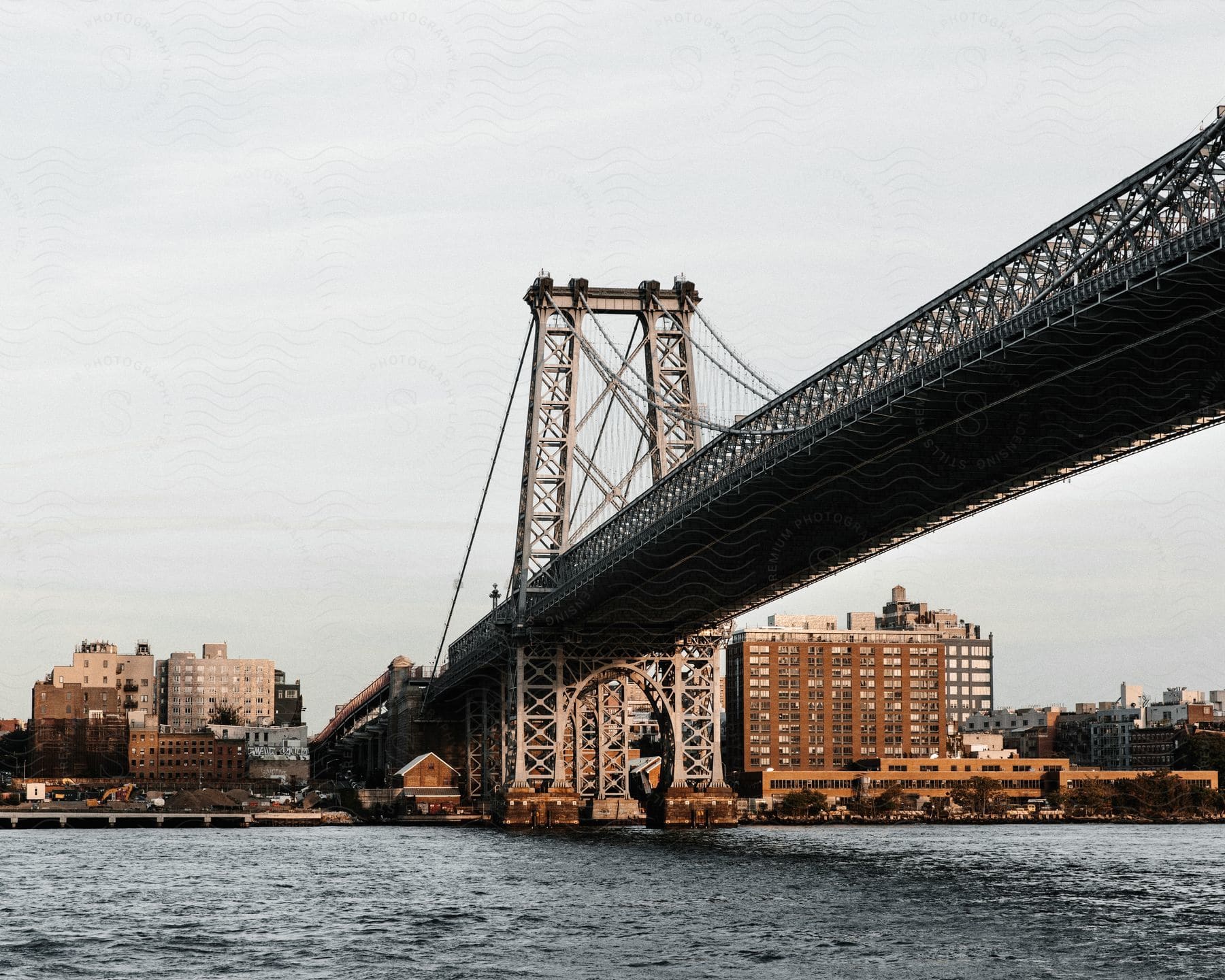 Williamsburg bridge next to the waterfront in a metropolitan city