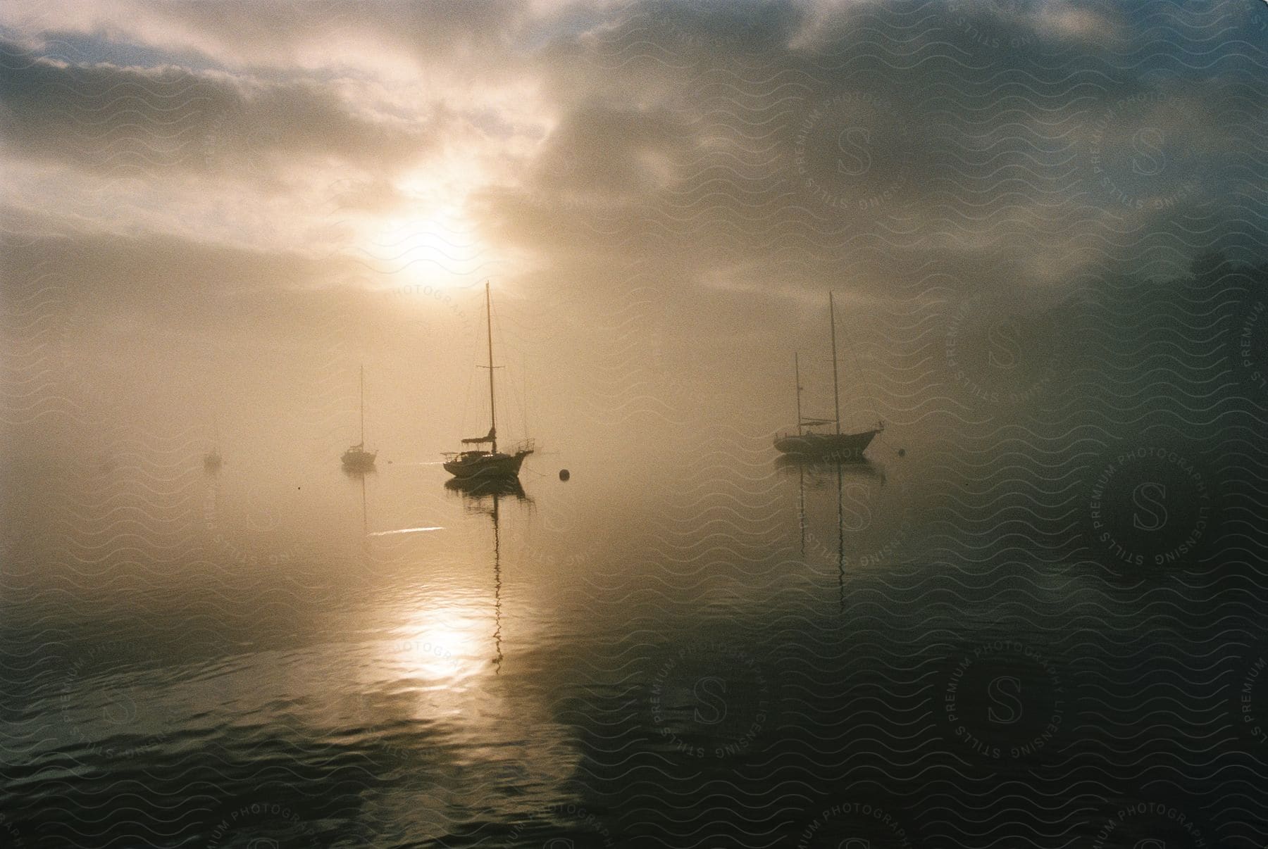 Boats sail on the sea at dawn