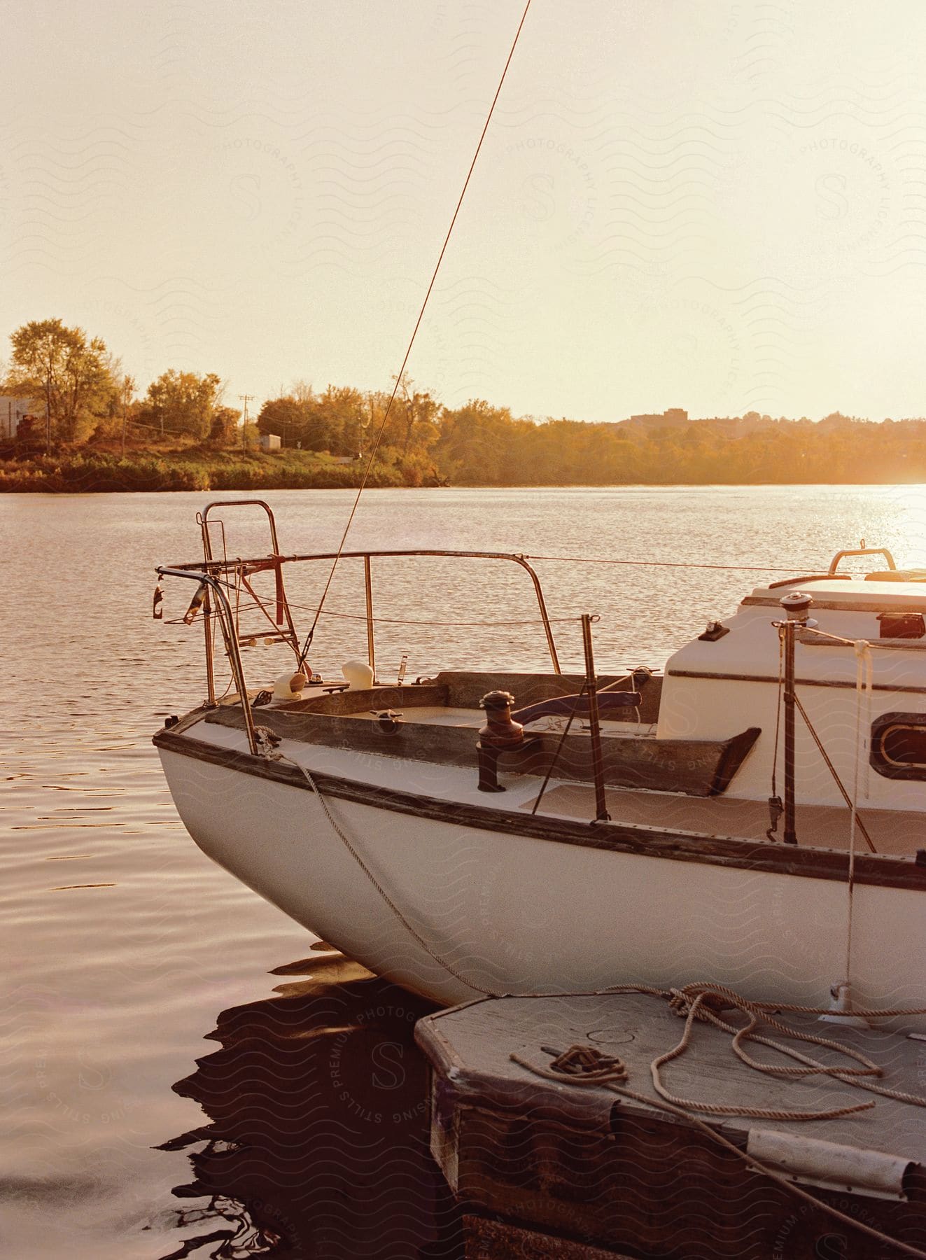 A boat is docked on a lake at sunset