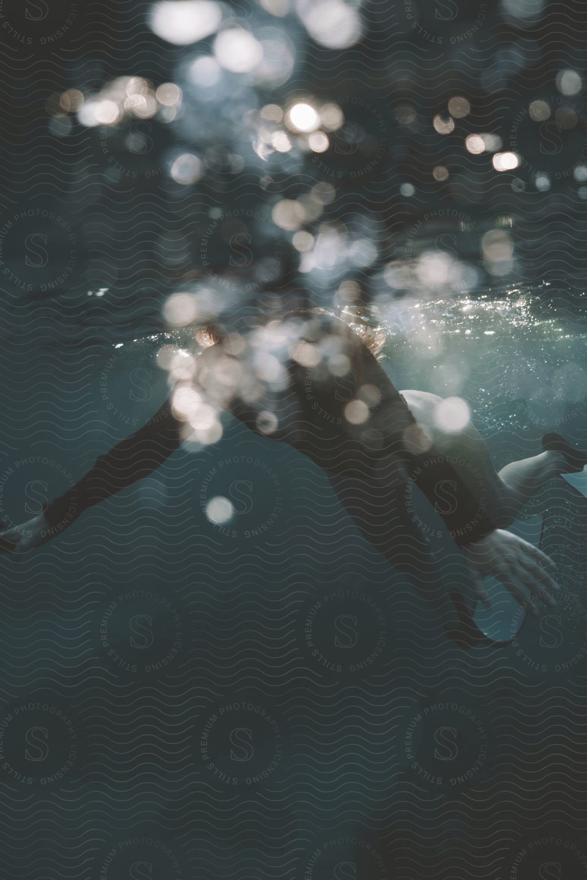 A man scuba diving near the water surface