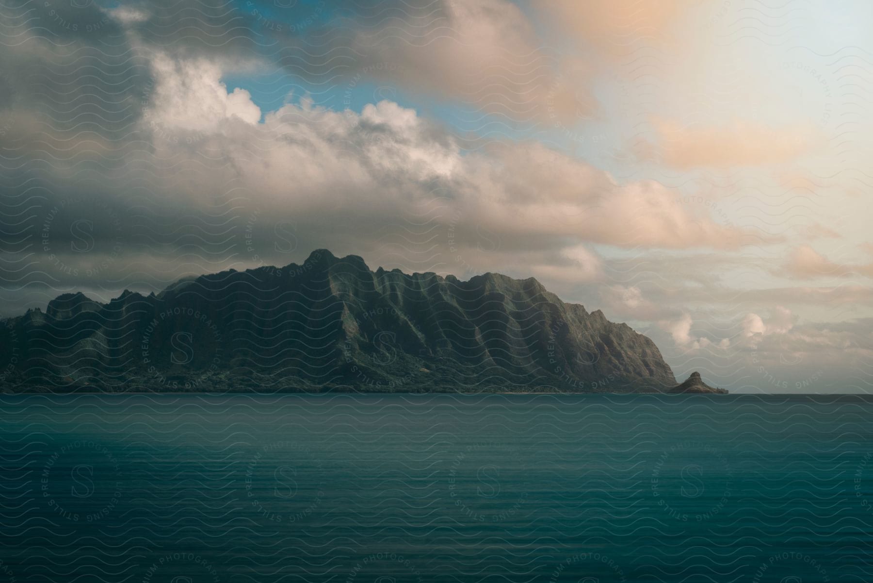 Clouds hang above tall cliffs on the coast