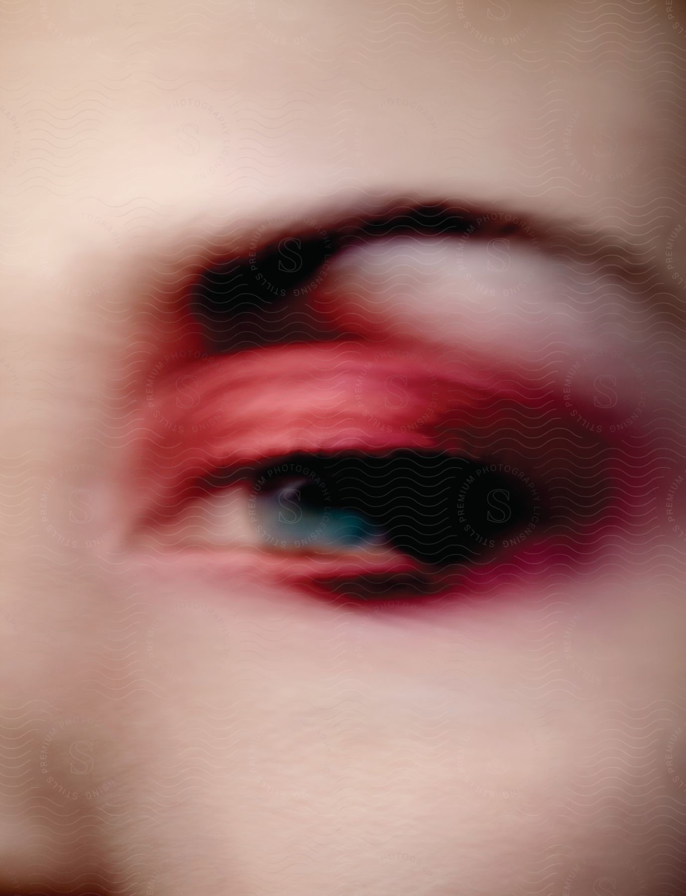 A blue eye with red eyeshadow