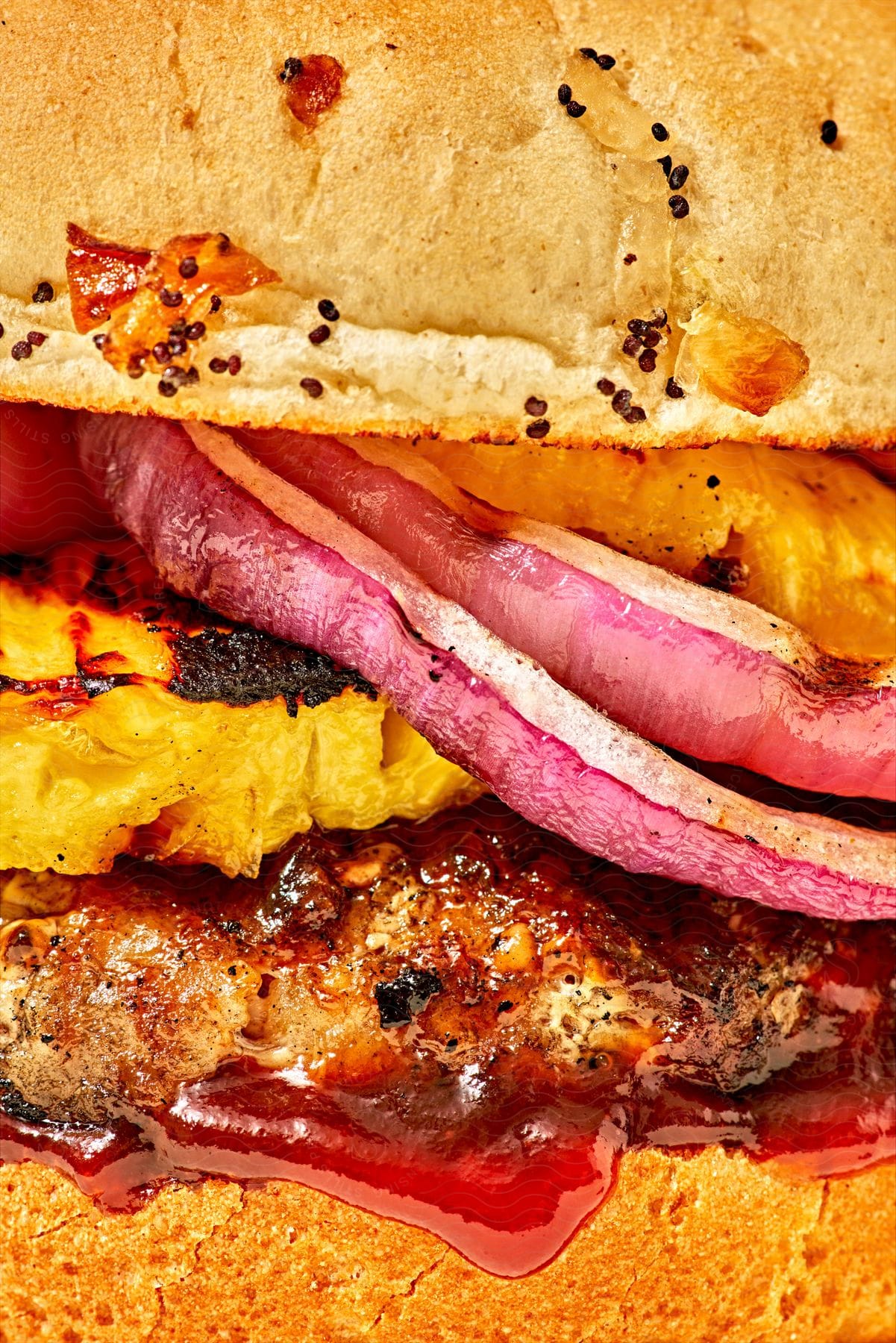 Stock photo of extreme close up of juicy fillings and ingredients on a hamburger