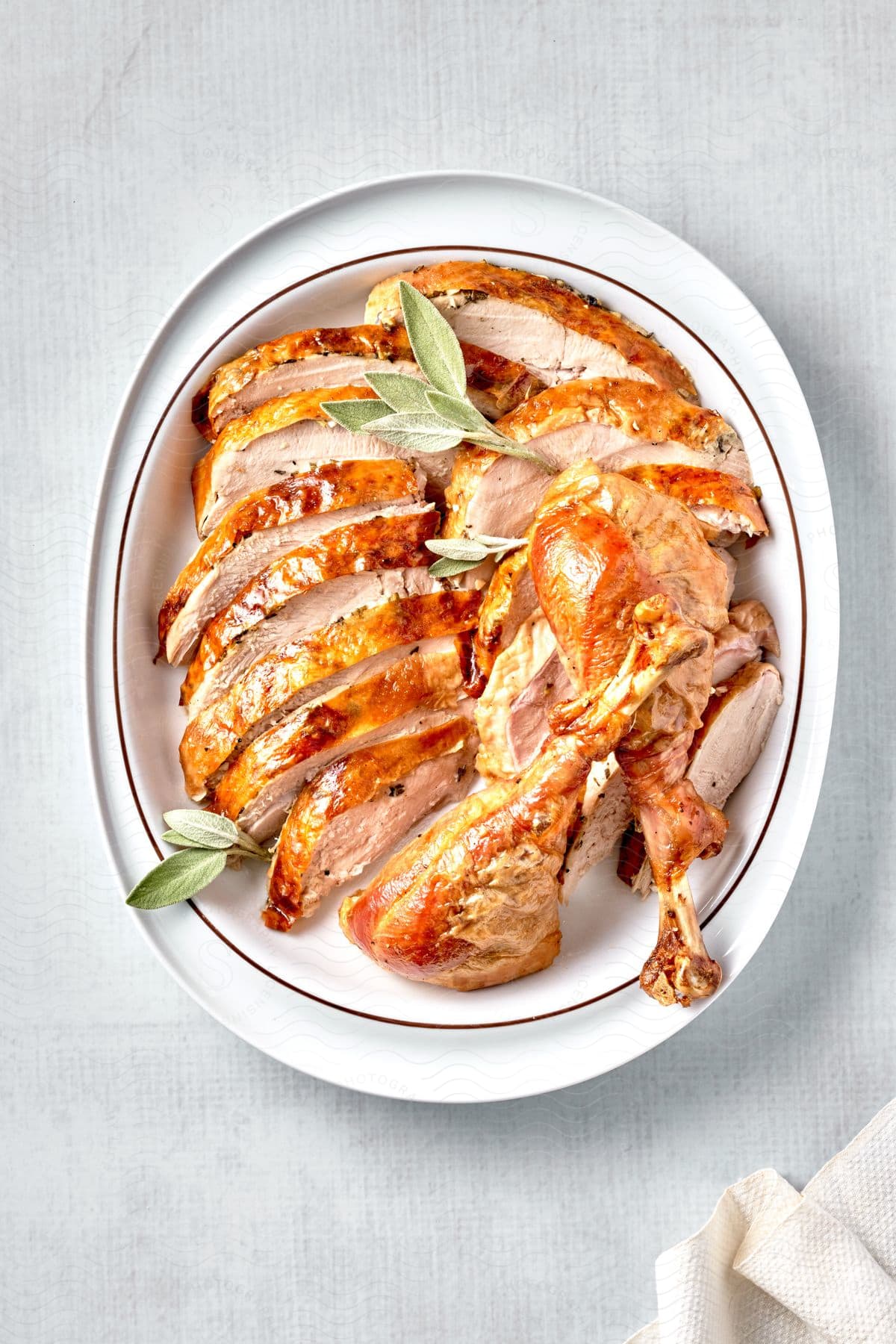 A table with a cooked roast tableware and ingredients for a meal