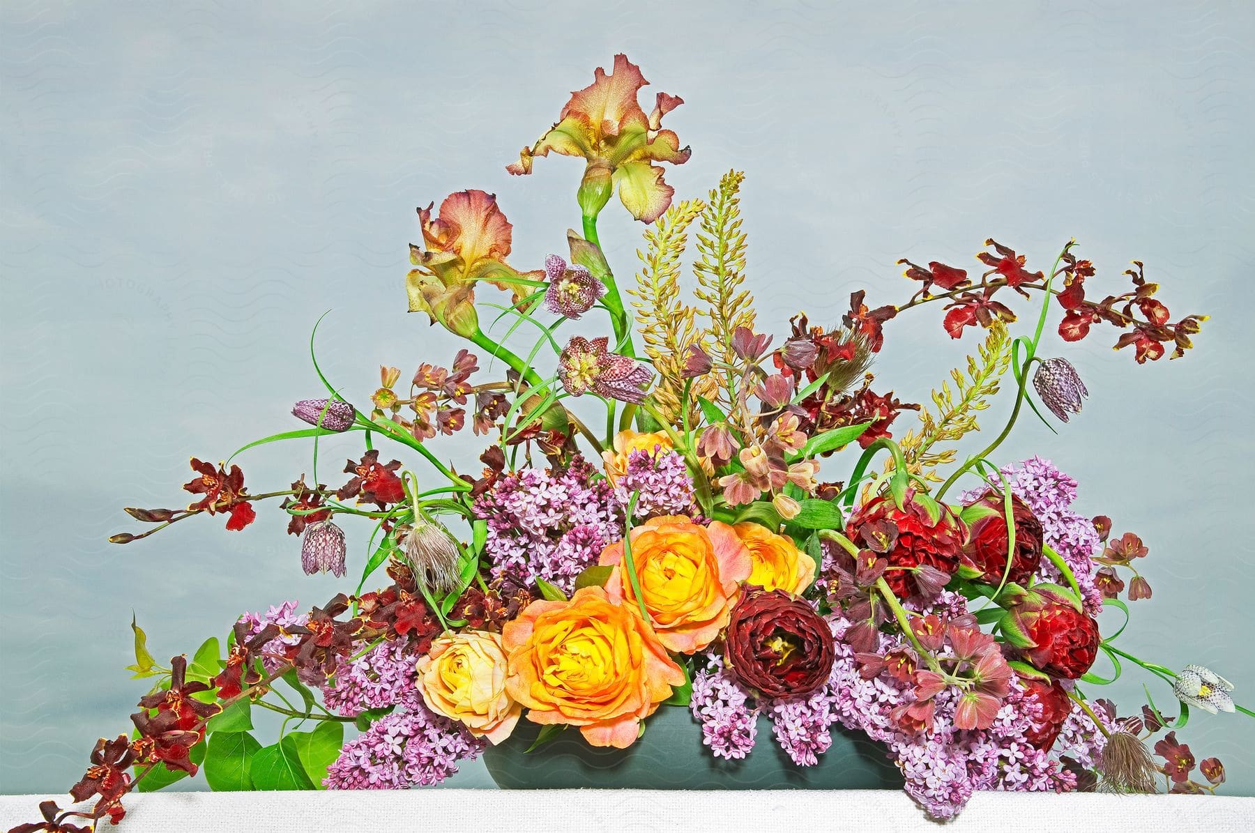A flower arrangement with plants on top of a table