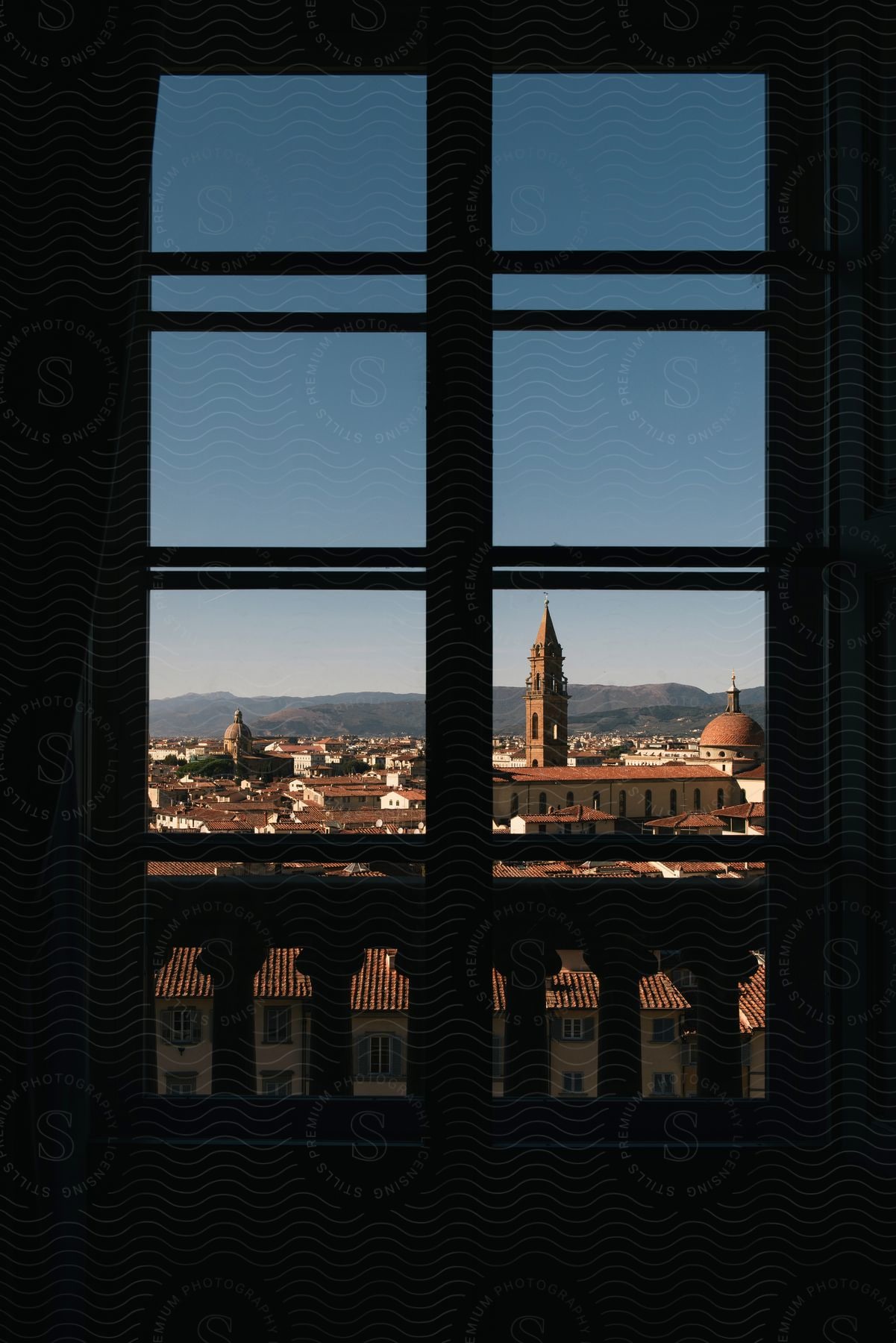 A sunny day in florence italy seen through a hotel window and balcony