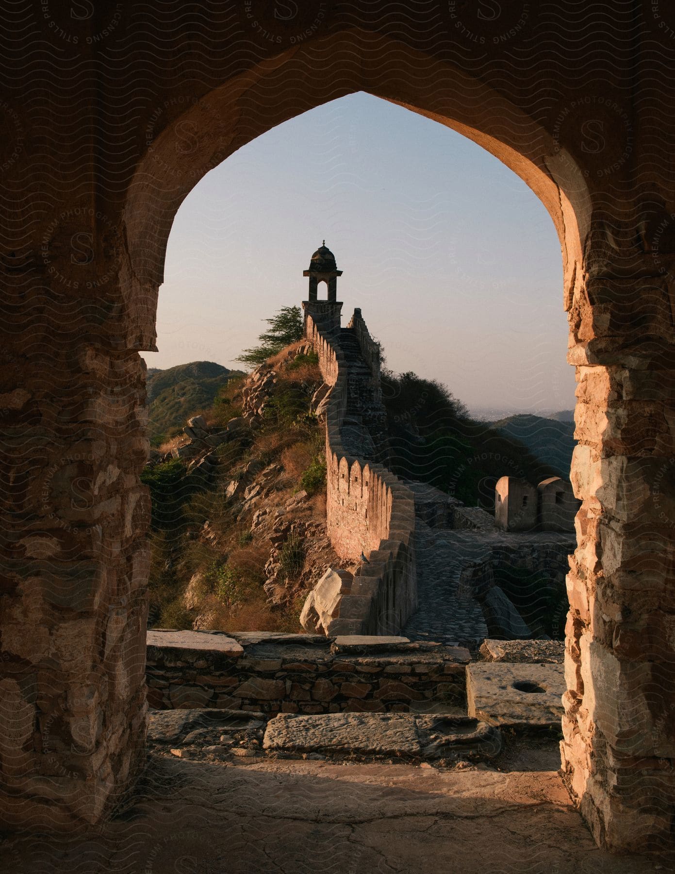 An architectural structure with a towerlike appearance resembling a lighthouse or fortress set against a sky background