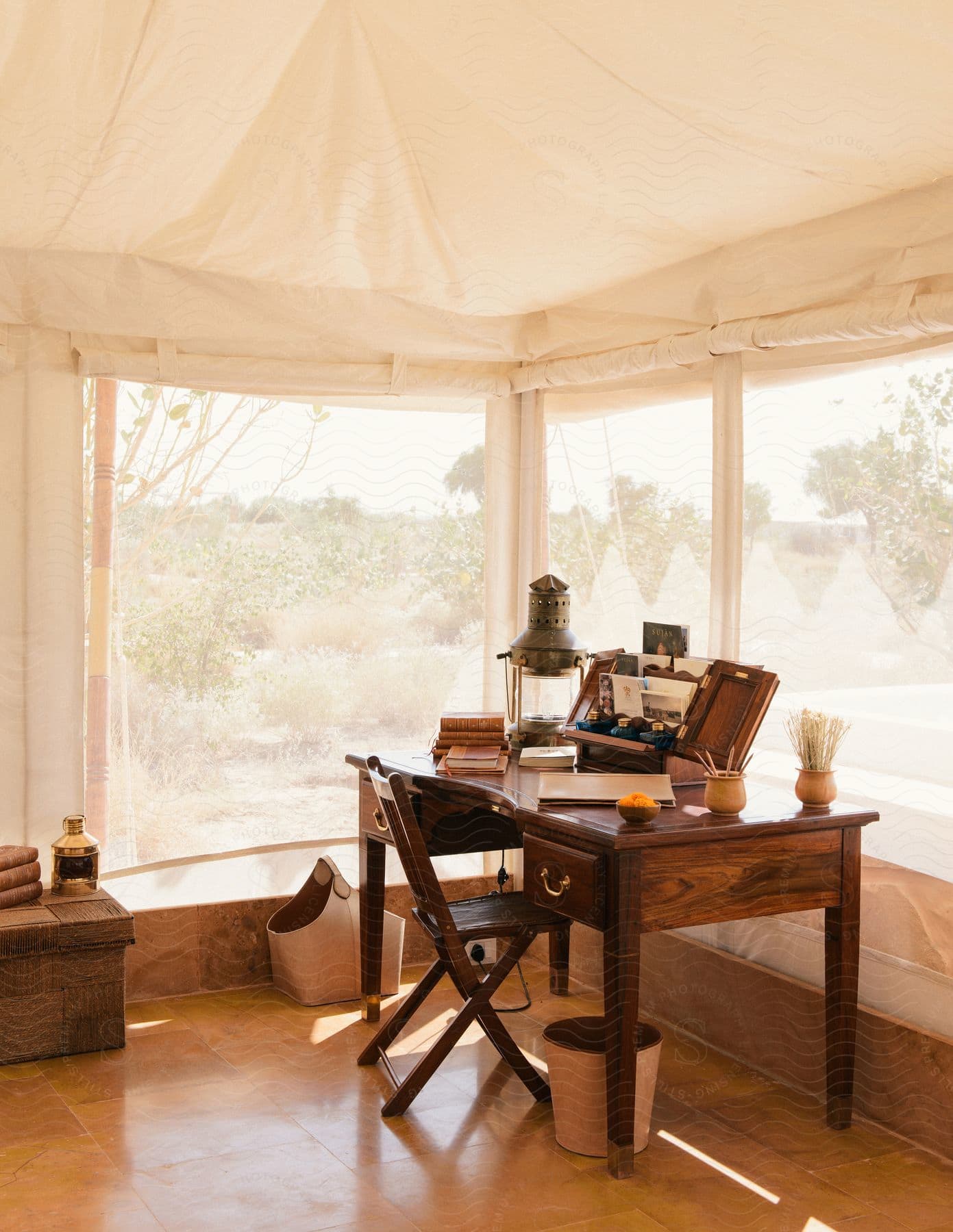 A camp office with a desk and chair set up