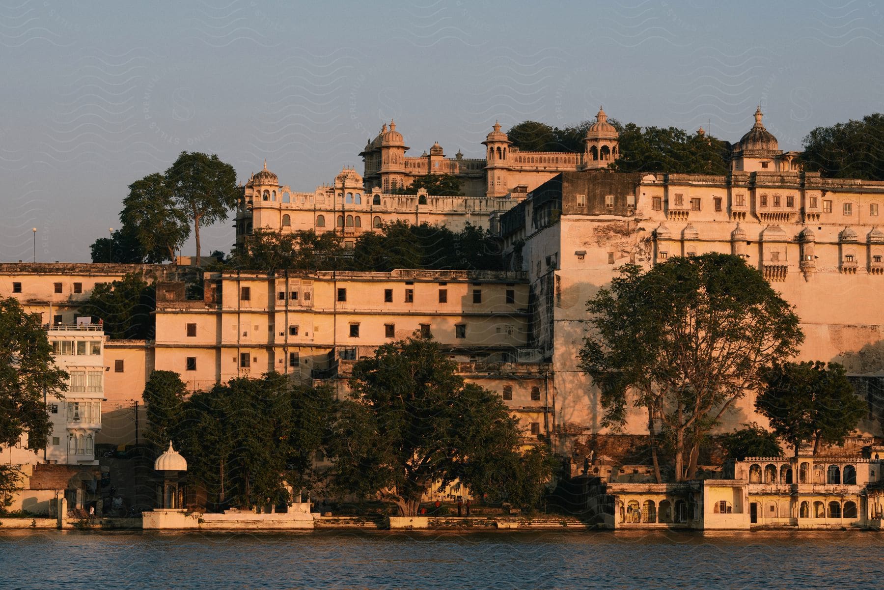 A city palace at dusk seen from a lake