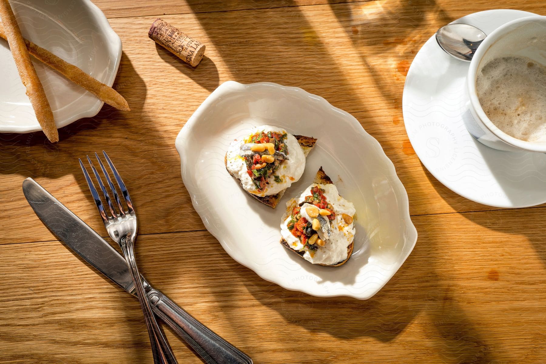 A fancy egg dish and foamy beverage are displayed on a wooden surface for brunch