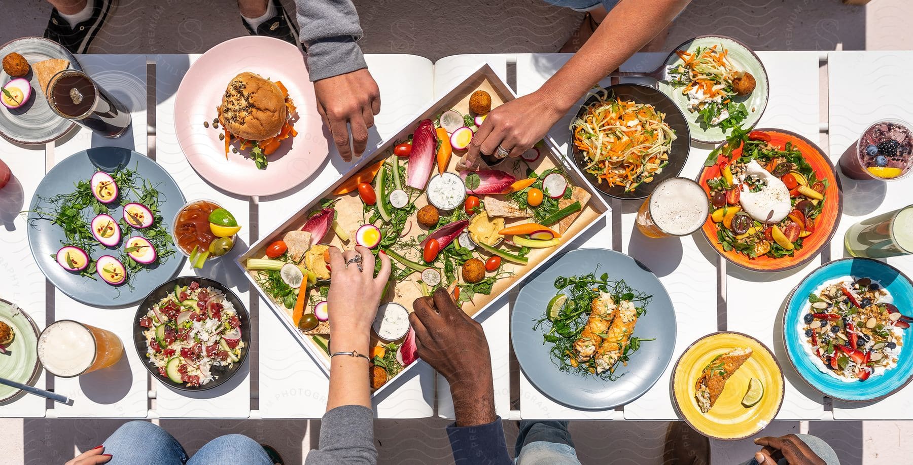 A small group of people enjoying their brunch meal at an outdoor location