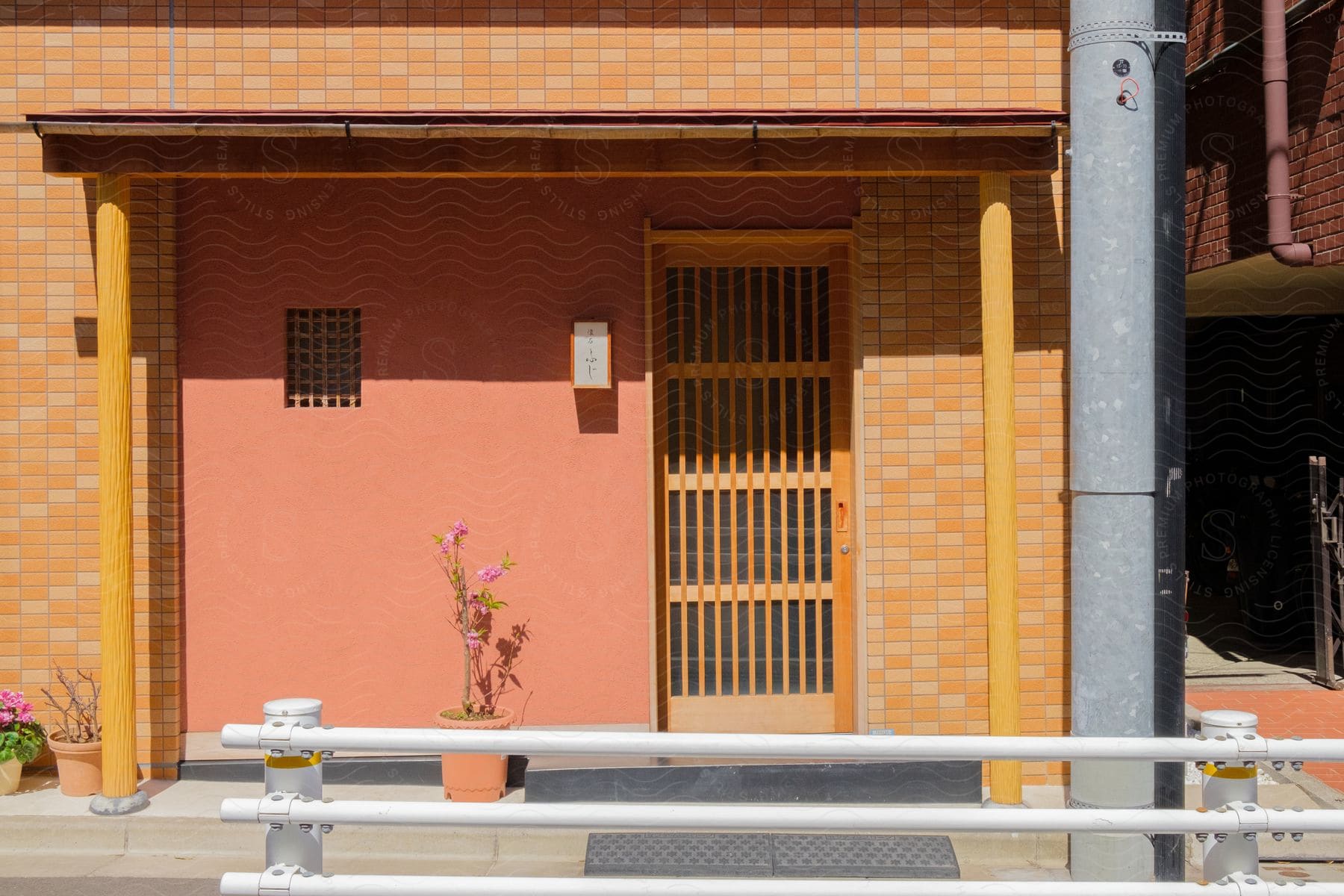 Exterior of a small japanese building with a window and door