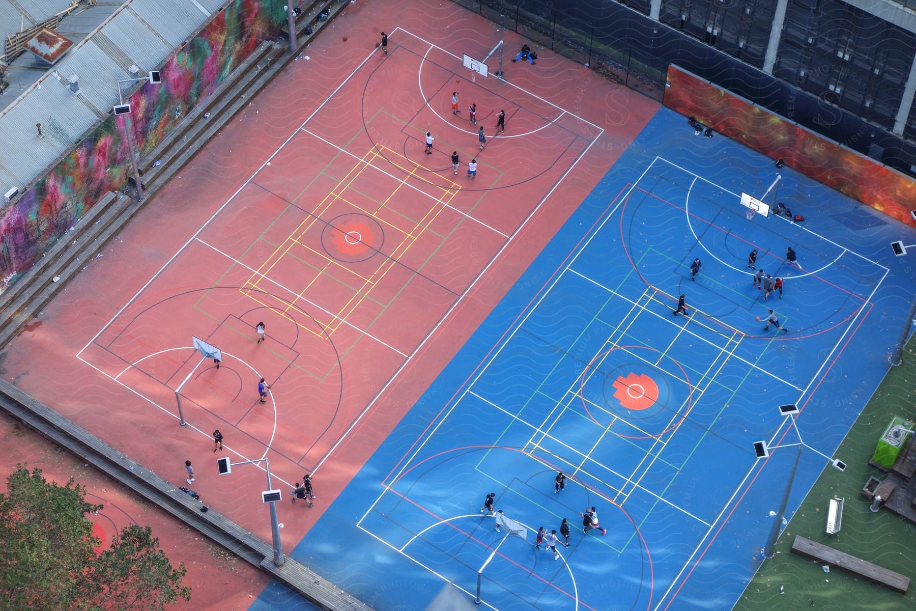Aerial view of people playing basketball on outdoor courts