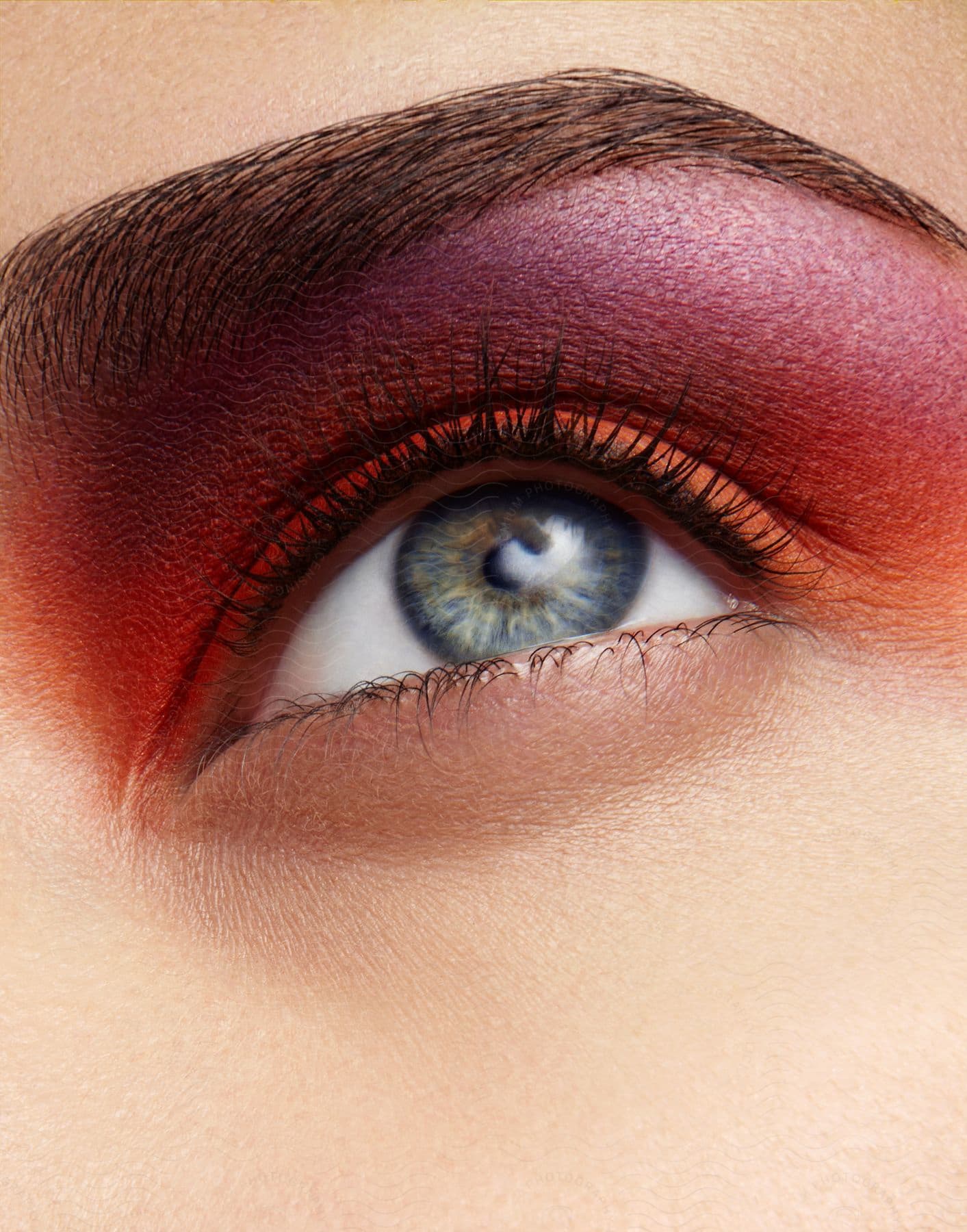 Stock photo of close up of a womans blue eye with eyeshadow