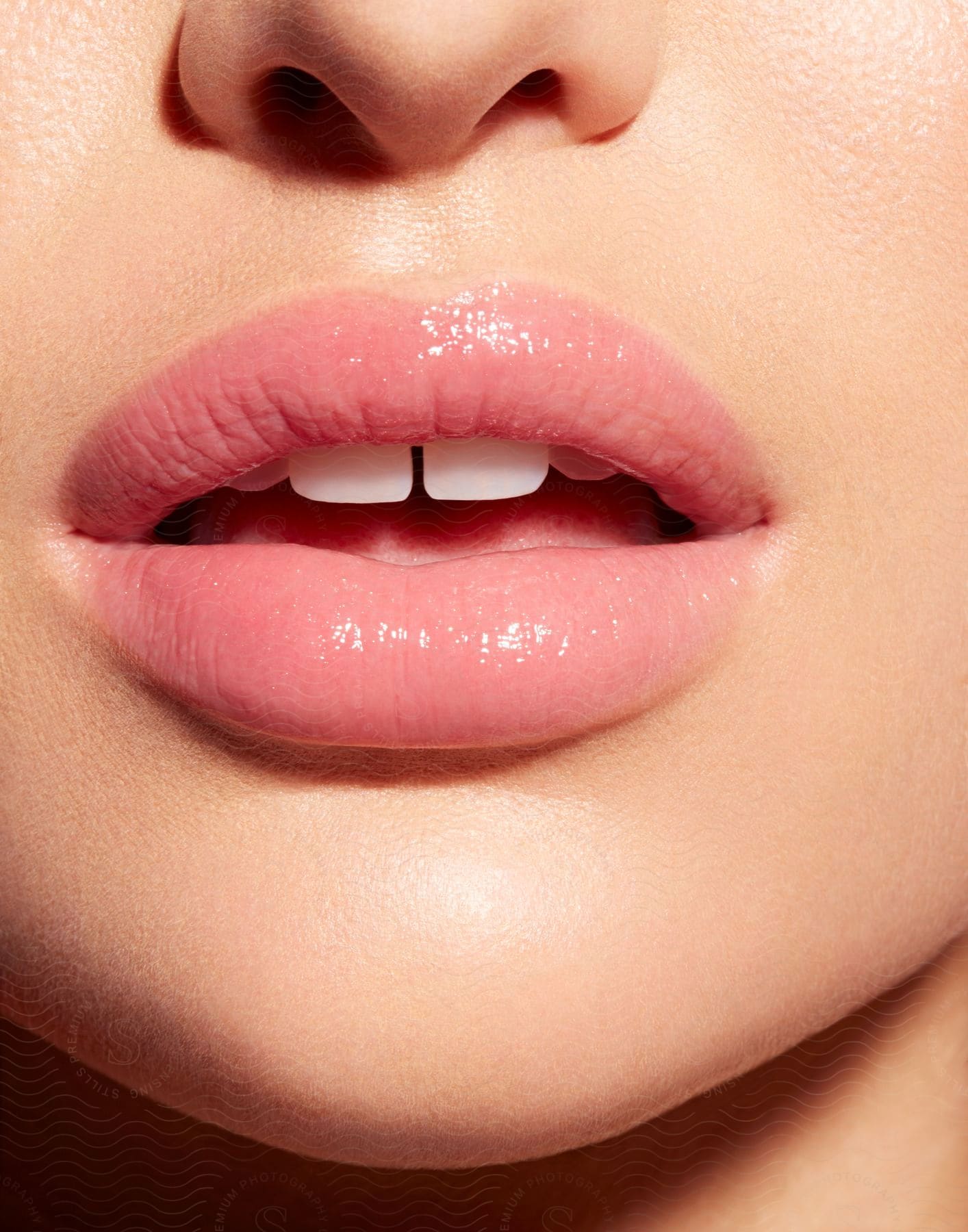 A woman with a lipstickcovered mouth sits with her mouth slightly open