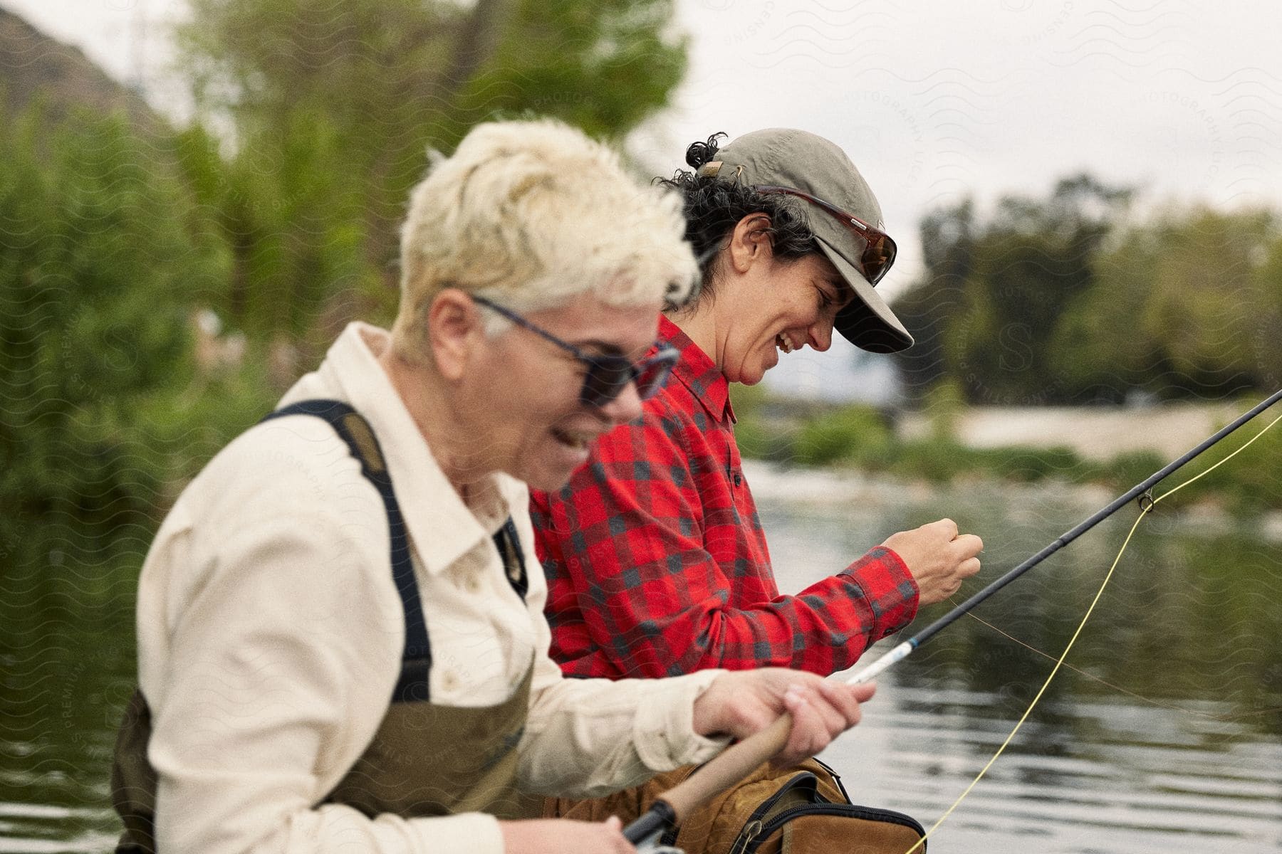 Two women fishing on a lake during the day