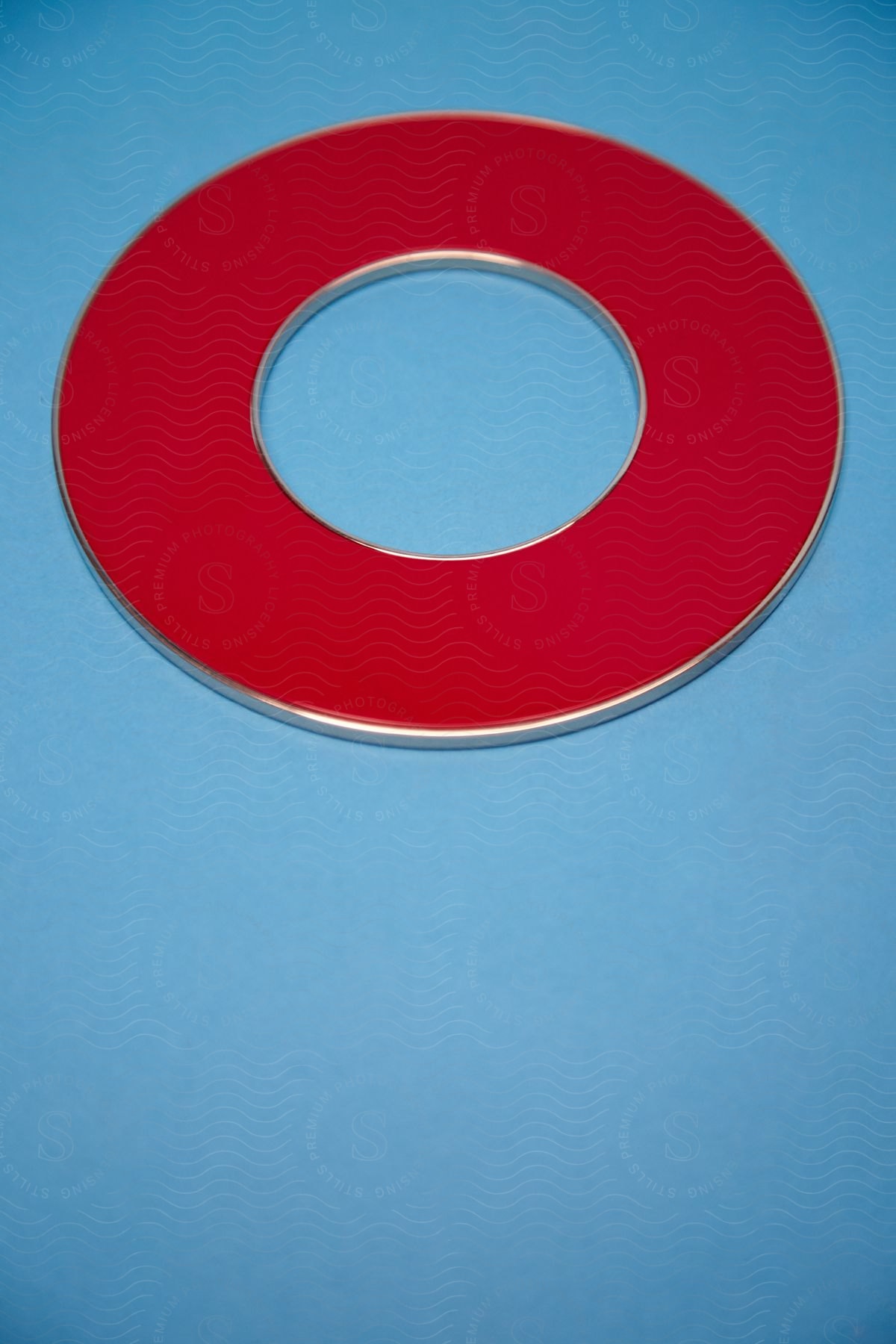 A blue surface with a round red object placed on it