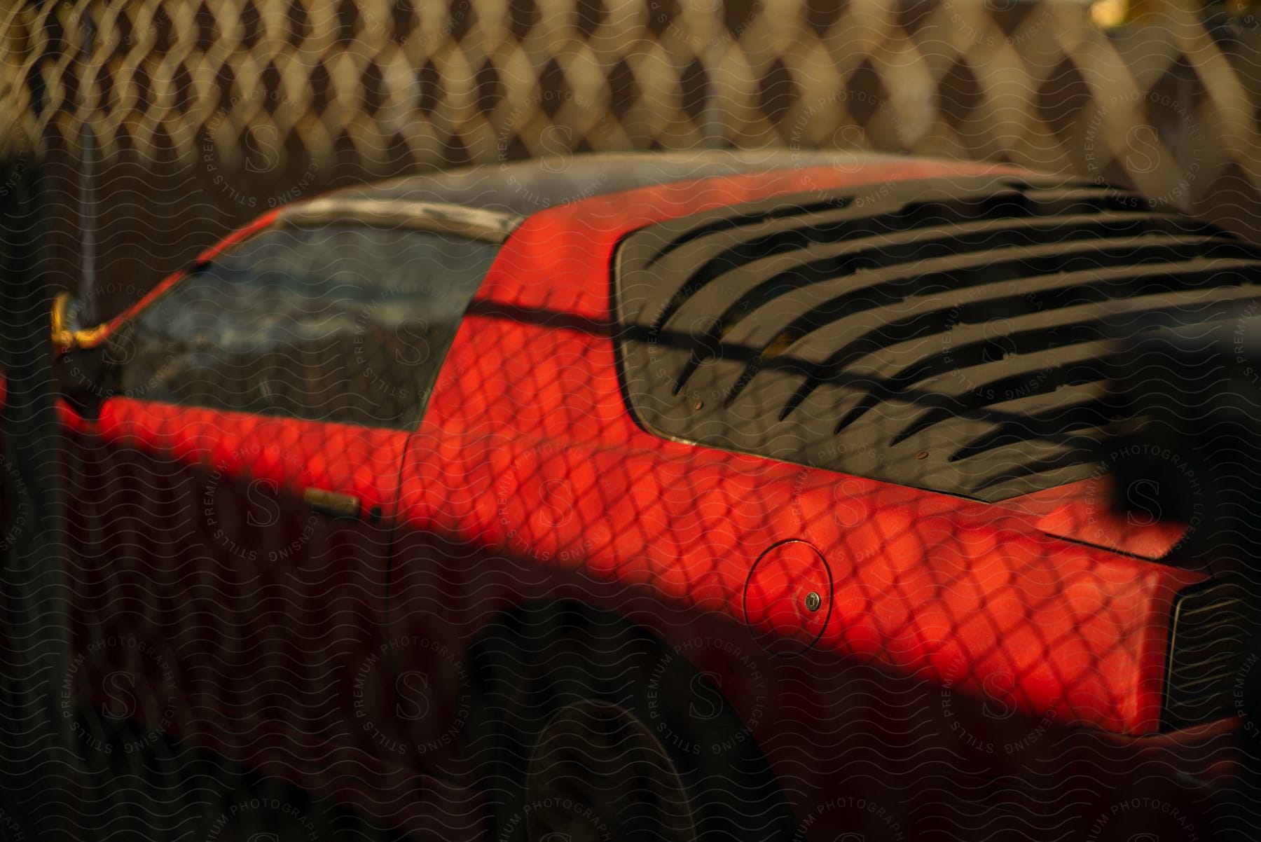 A red car with the sun setting