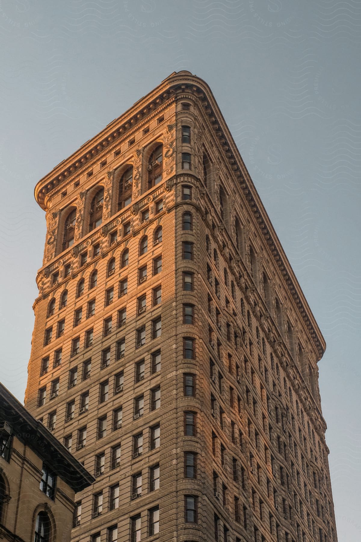 An old stone skyscraper with detailed stone carving at the top