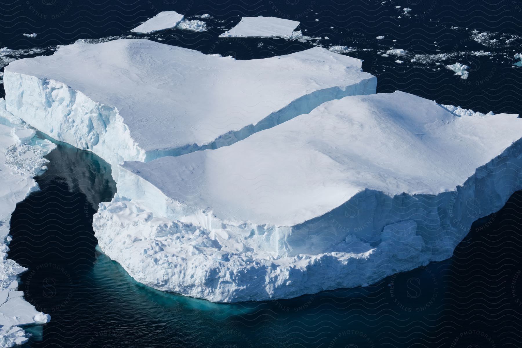 Various sized glaciers and ice pieces are seen on the ocean