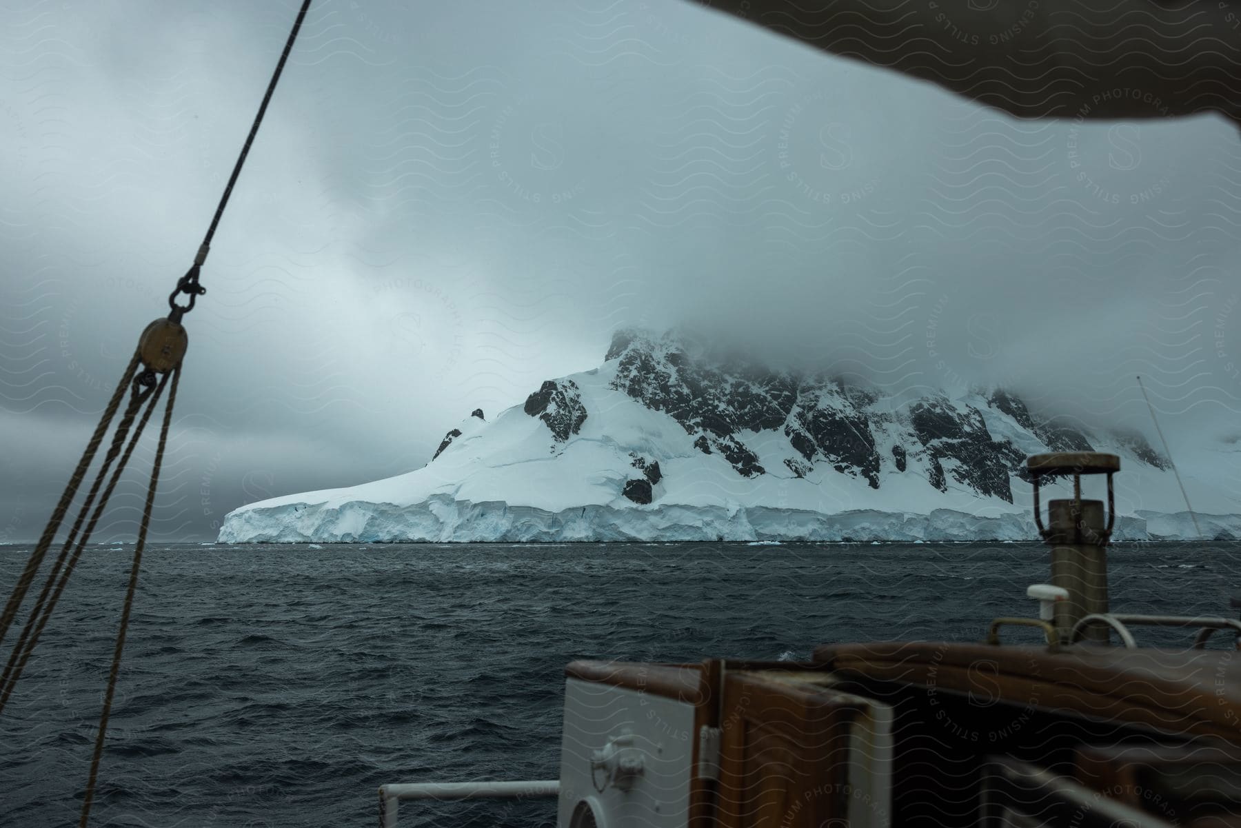 A boat passing a snowcovered natural landmark in antarctica