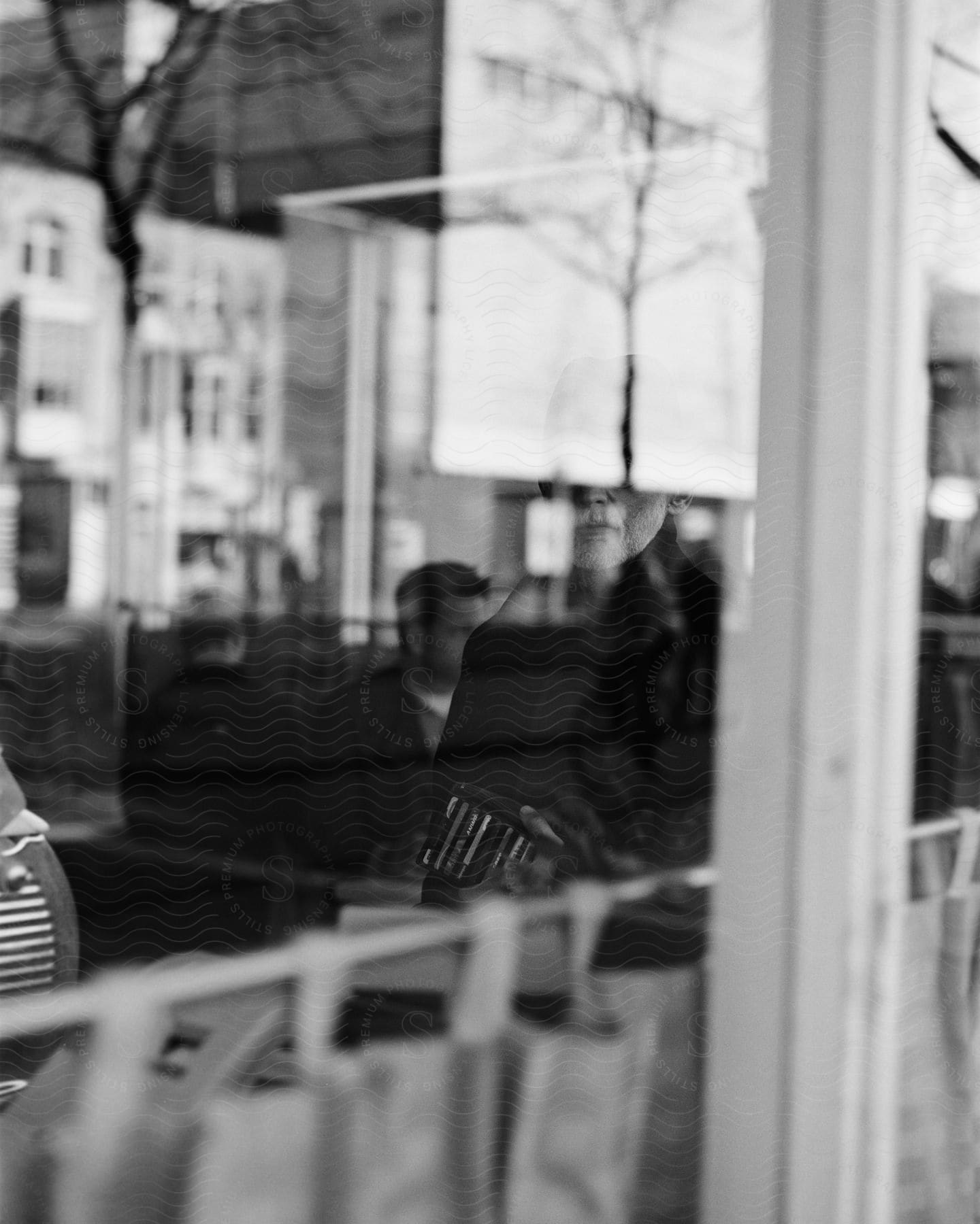 A man is seen through the reflection of a buildings window