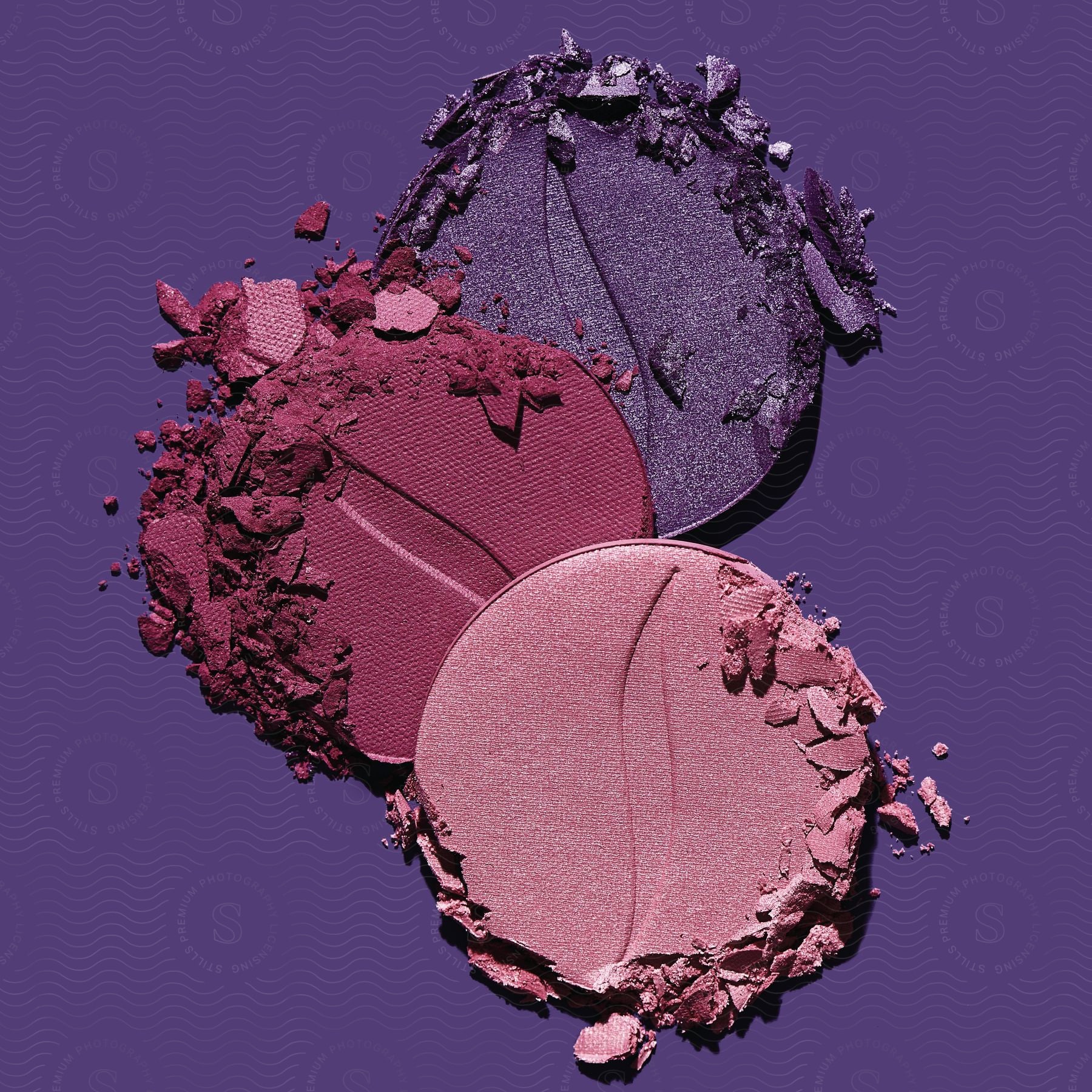 Stock photo of makeup brushes with eyeshadow on a purple background