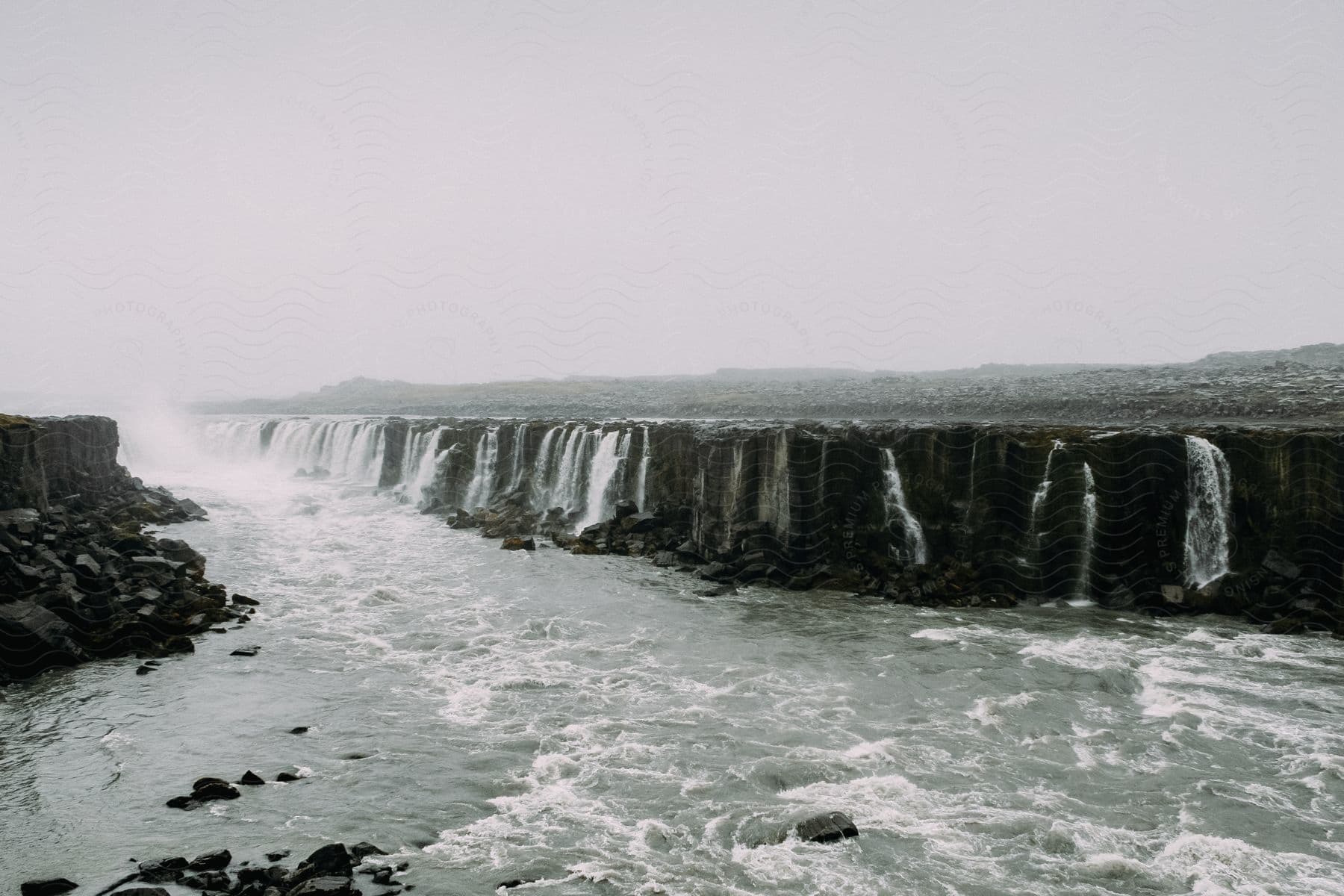 A serene natural landscape with a flowing watercourse