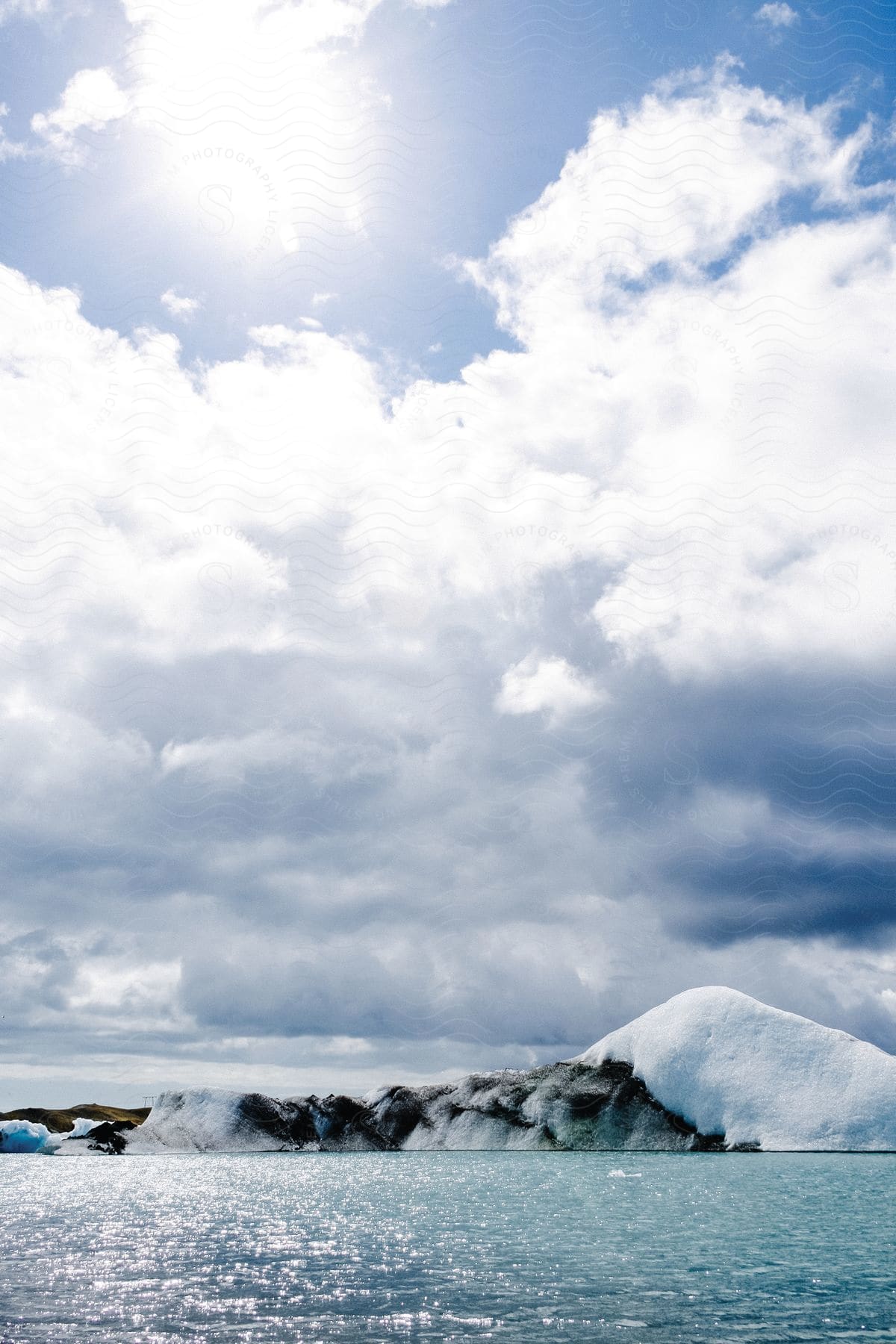 A sunny day in the arctic with ice floating in the water