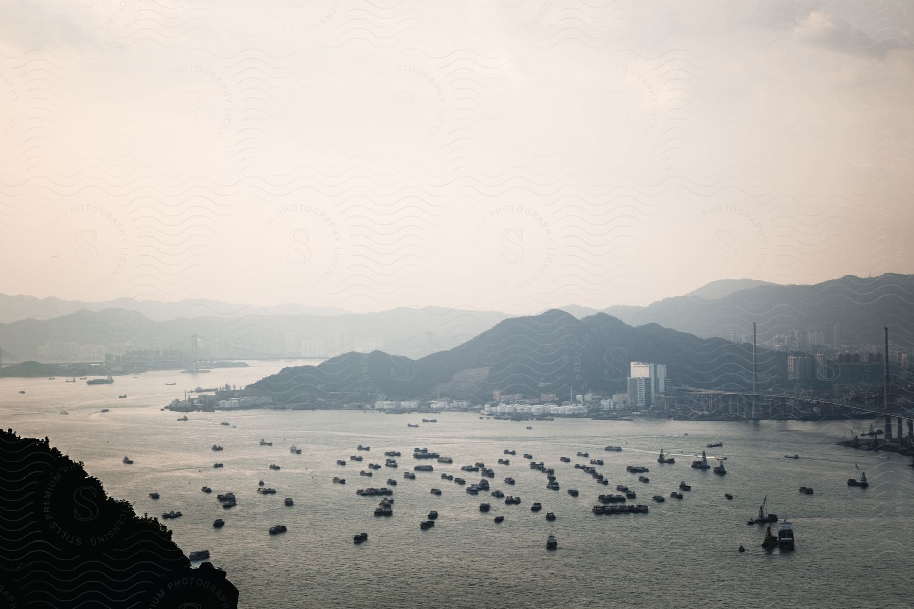 Aerial view of a cityscape near a shoreline with mountains and water