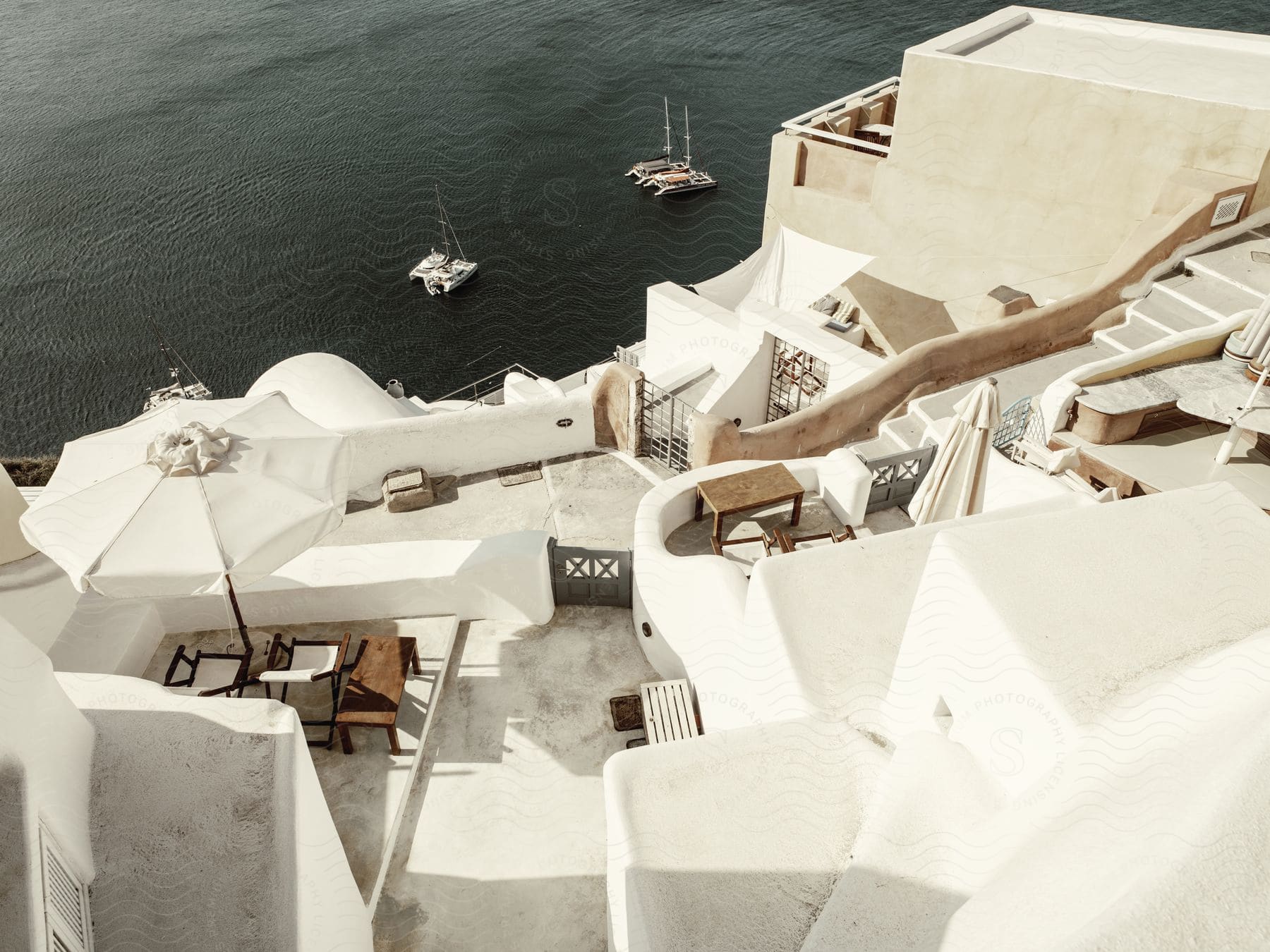 A vacation villa next to the ocean with sailboats in front