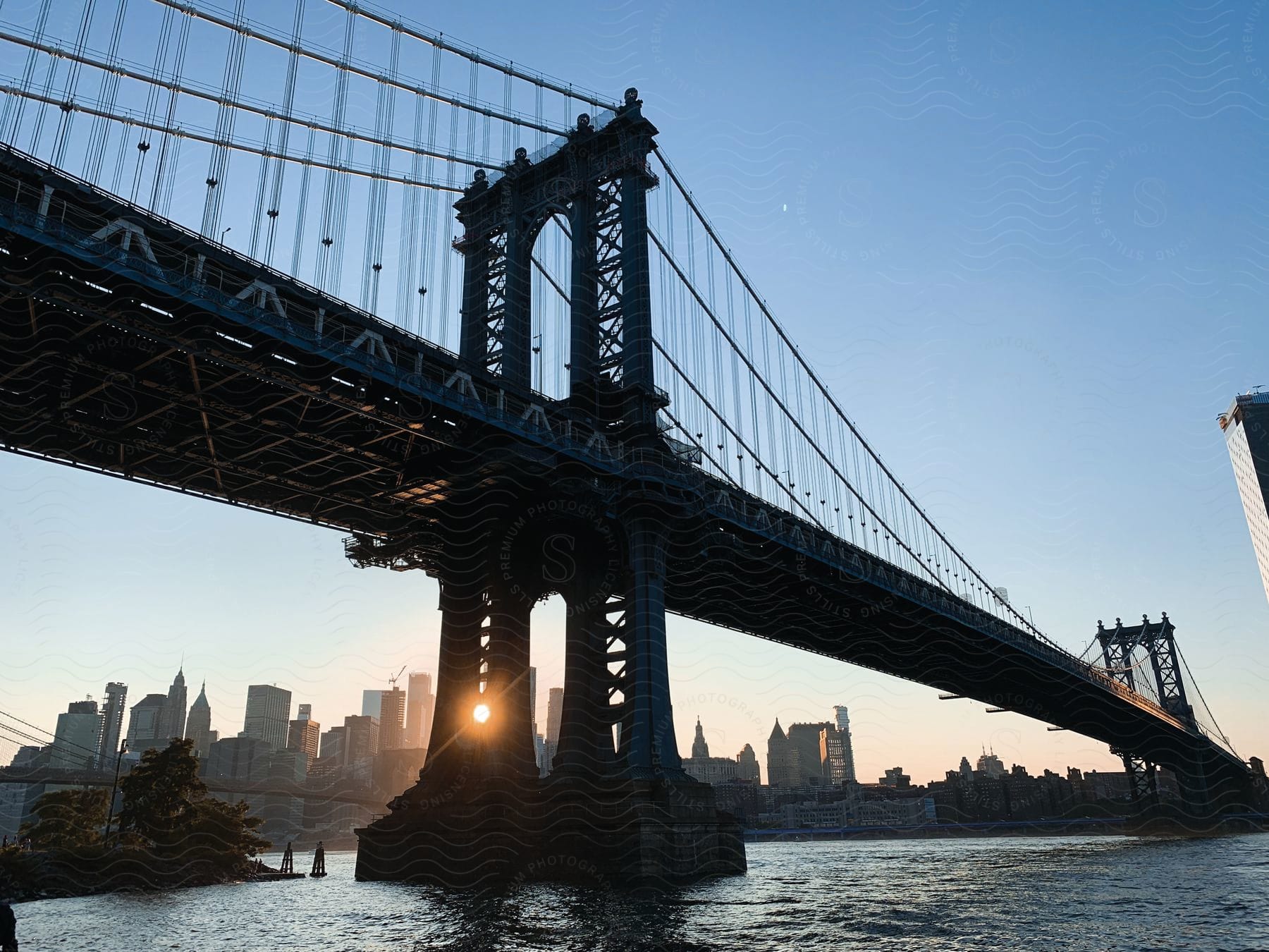 A steel line bridge linking two cities with skyscrapers seen from a distance