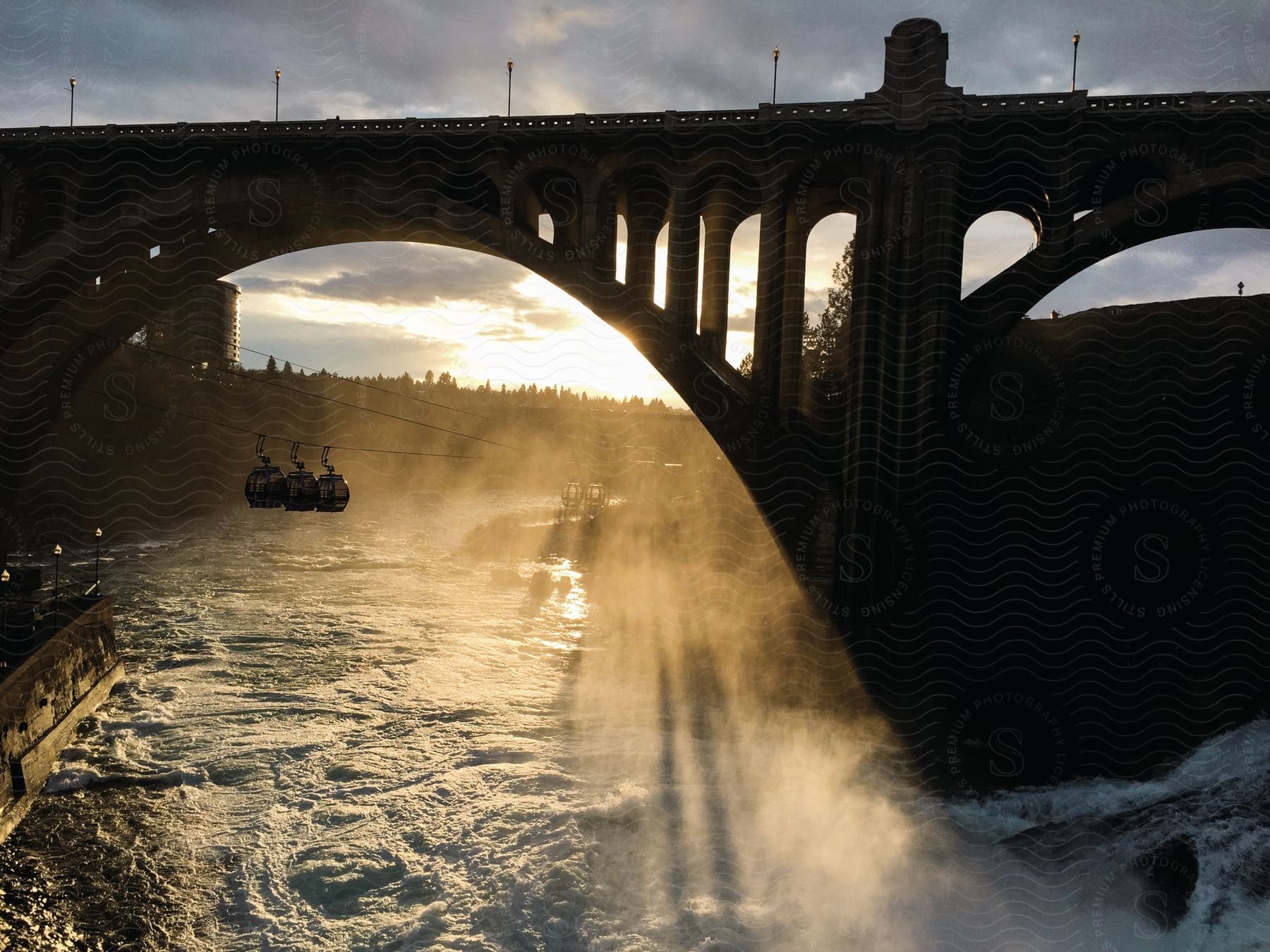 A boat on the water with a bridge in the background