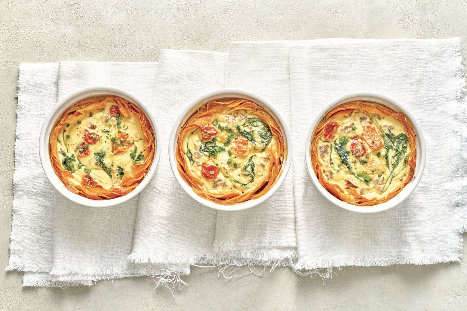 Three bowls of food are presented on a table