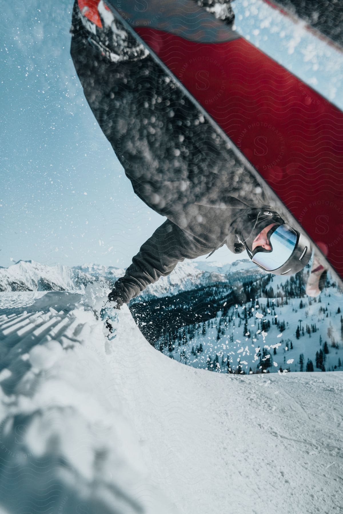 A snowboarder performing an impressive aerial stunt in midair