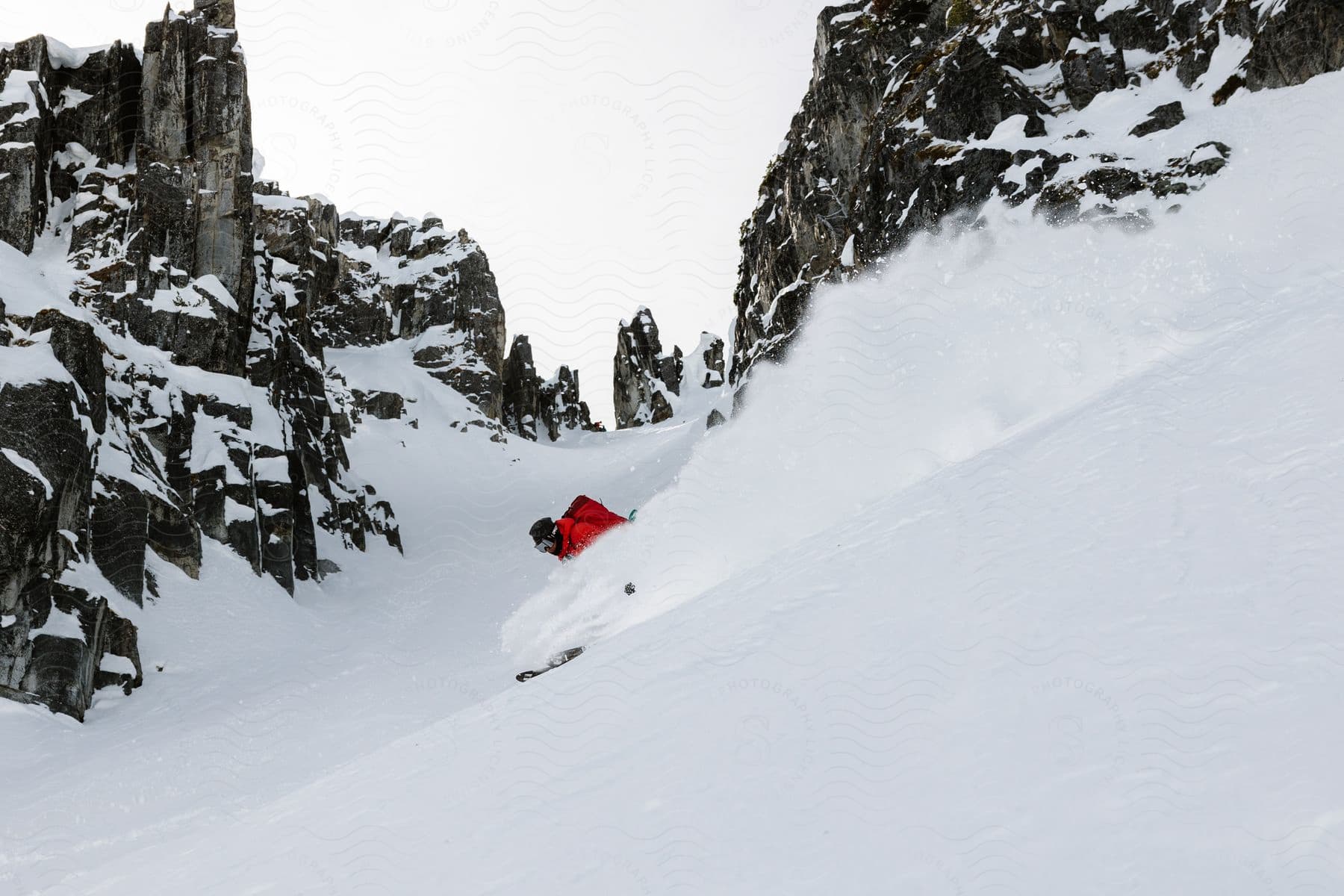 A snowy mountain slope with trees and sports equipment