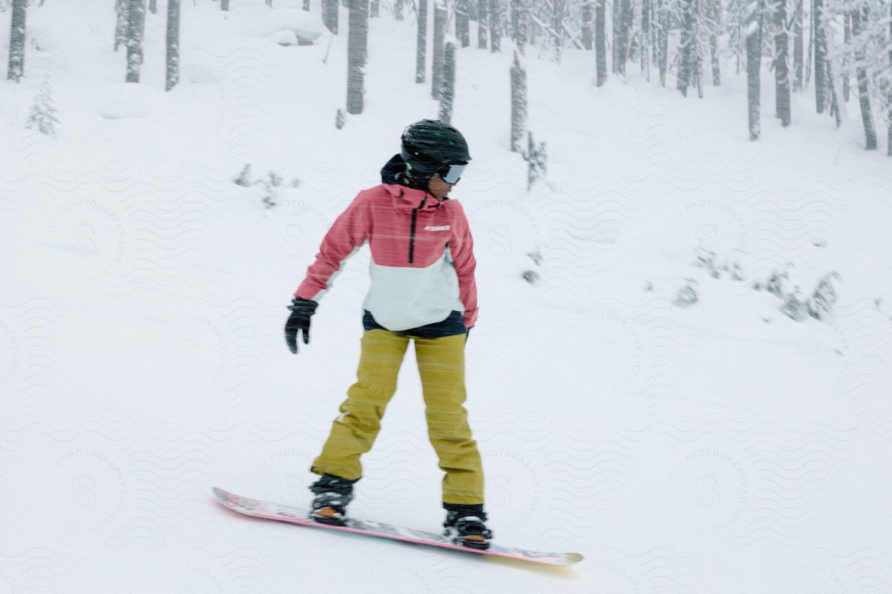 A girl skiing in colorful clothes on a snowy slope