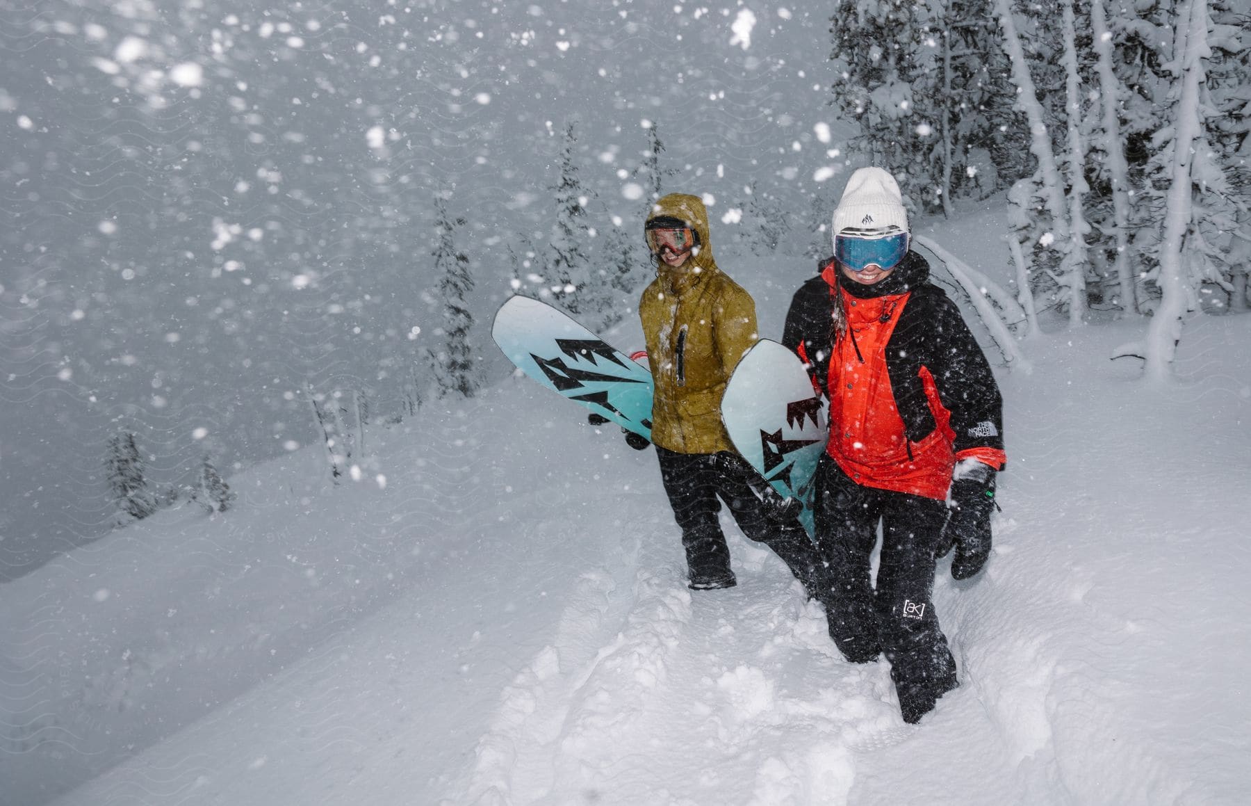 Two women snowboarding on a snow-covered mountain with smiling facial expressions.