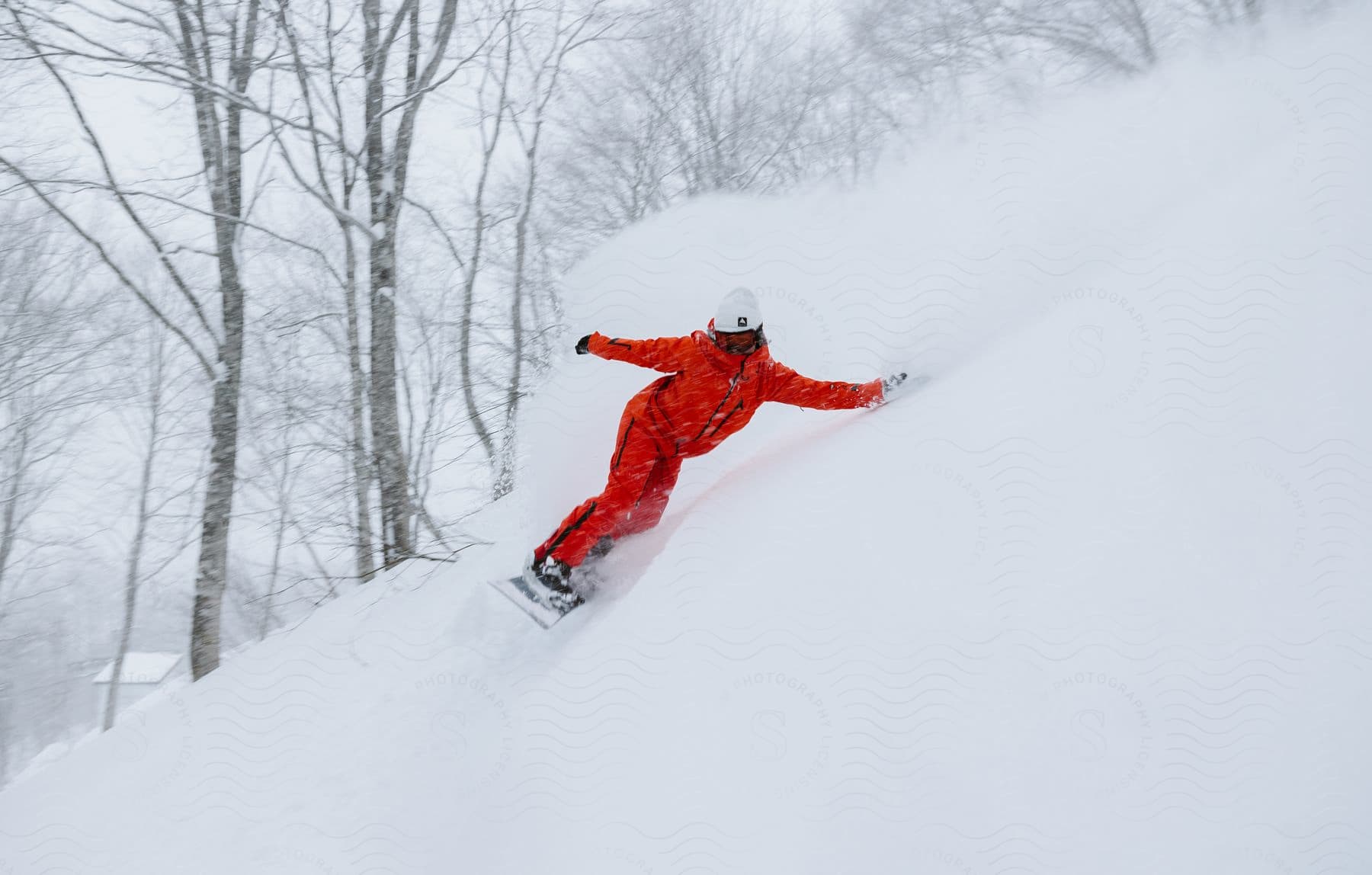 A person snowboarding on a snowy slope during winter