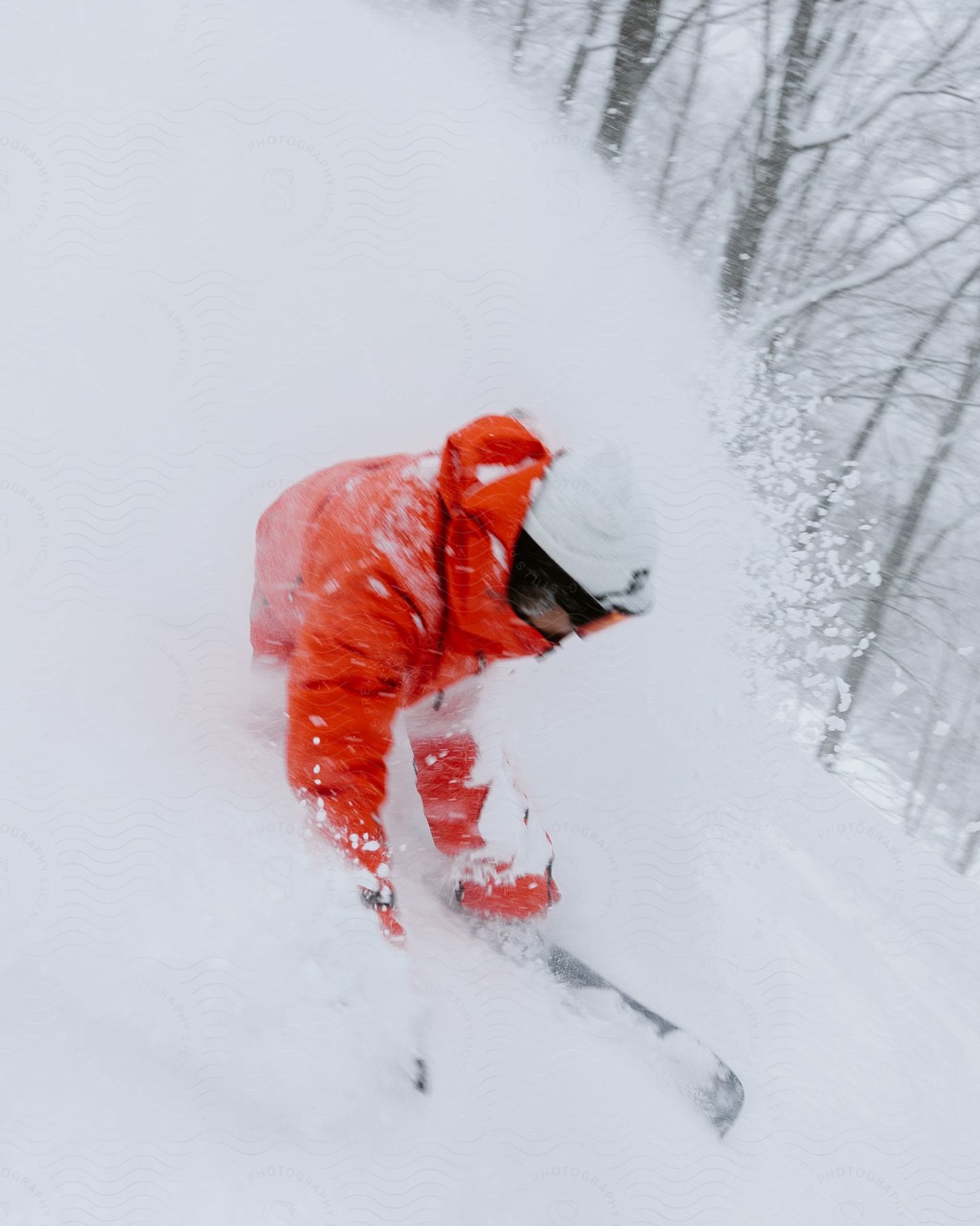 A person skiing down a slope in snowy outdoor conditions during the day