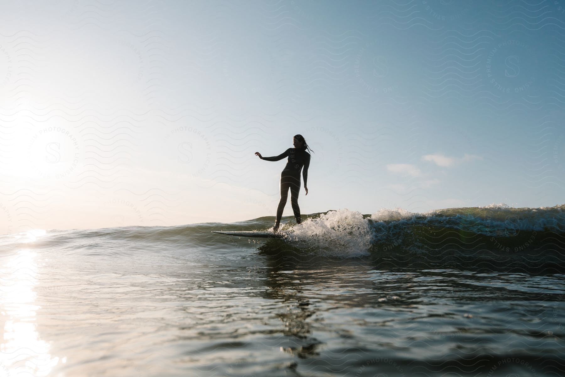 A woman is surfing in the daytime outdoors