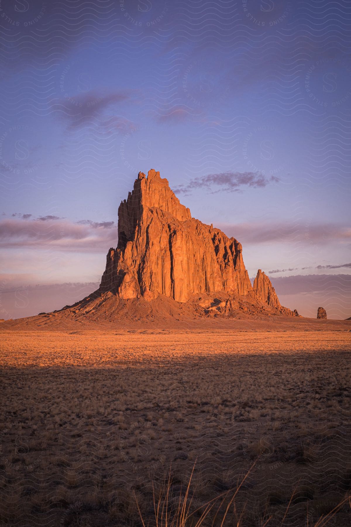 The sun shines on a large mountain peak