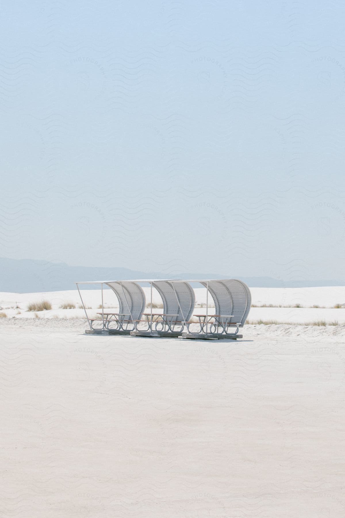 Sparse grass emerges alongside a solitary chair in an arid desert landscape