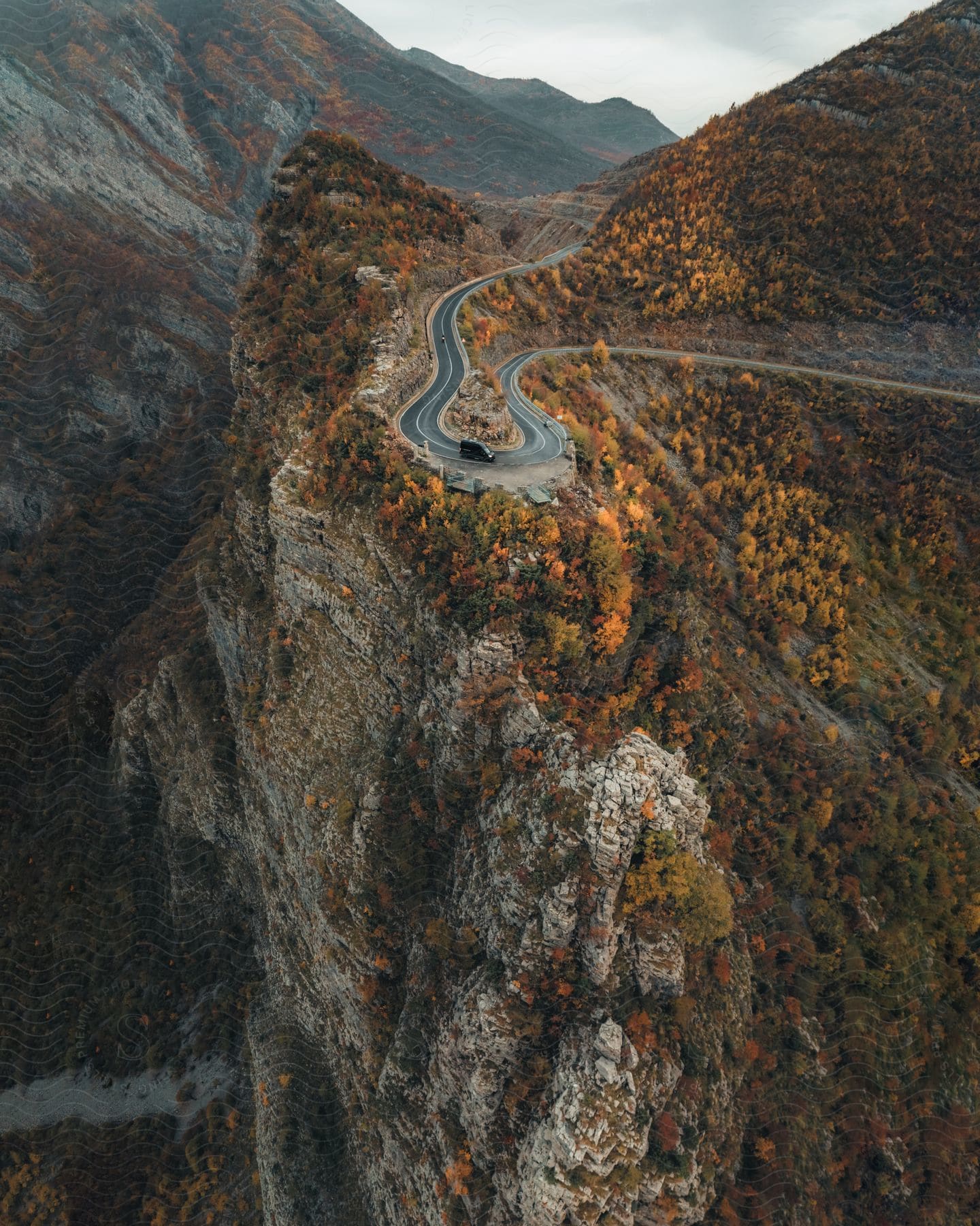 A van drives down a winding mountain road