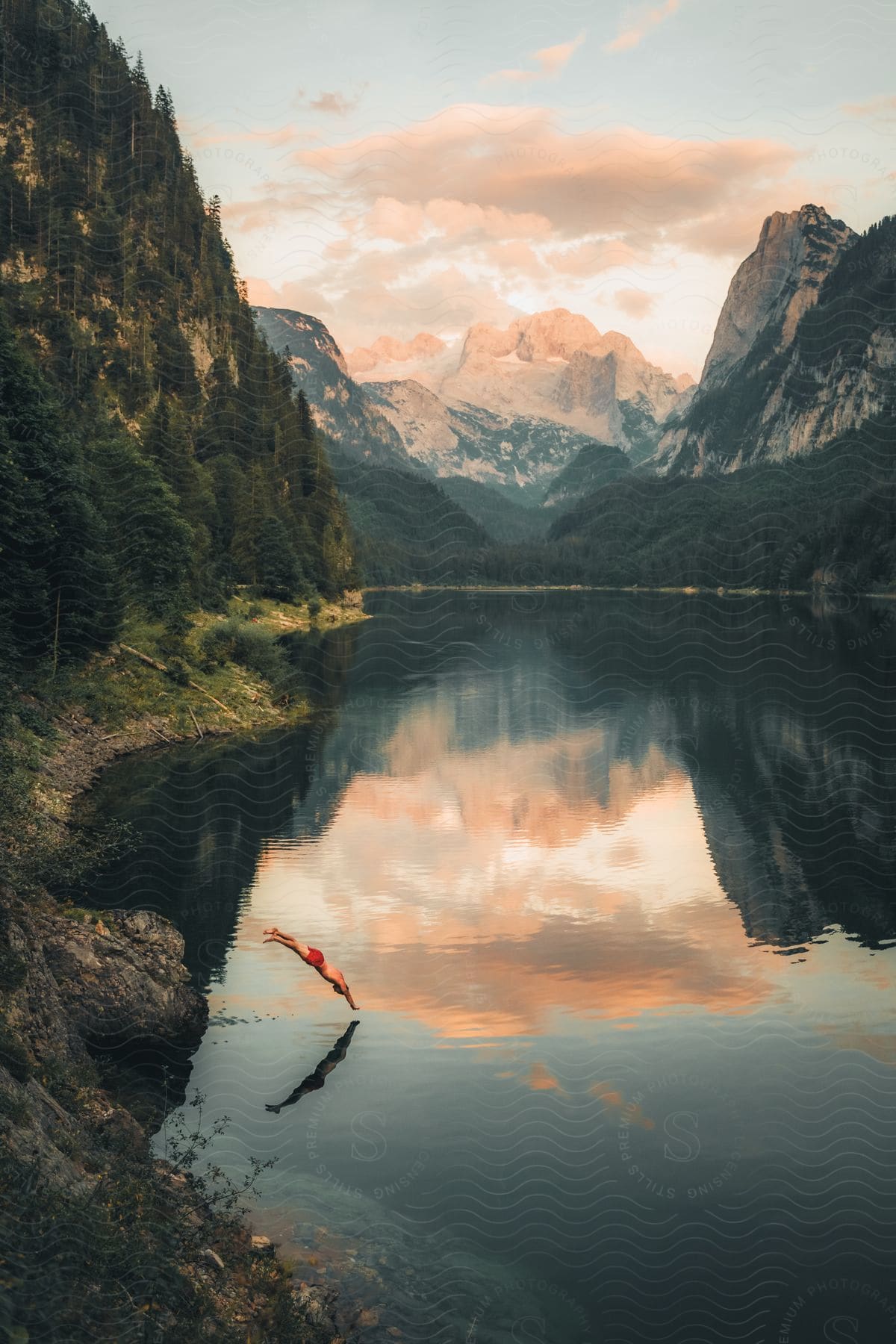 Colorful mountains surround a body of water on a cloudy day in austria