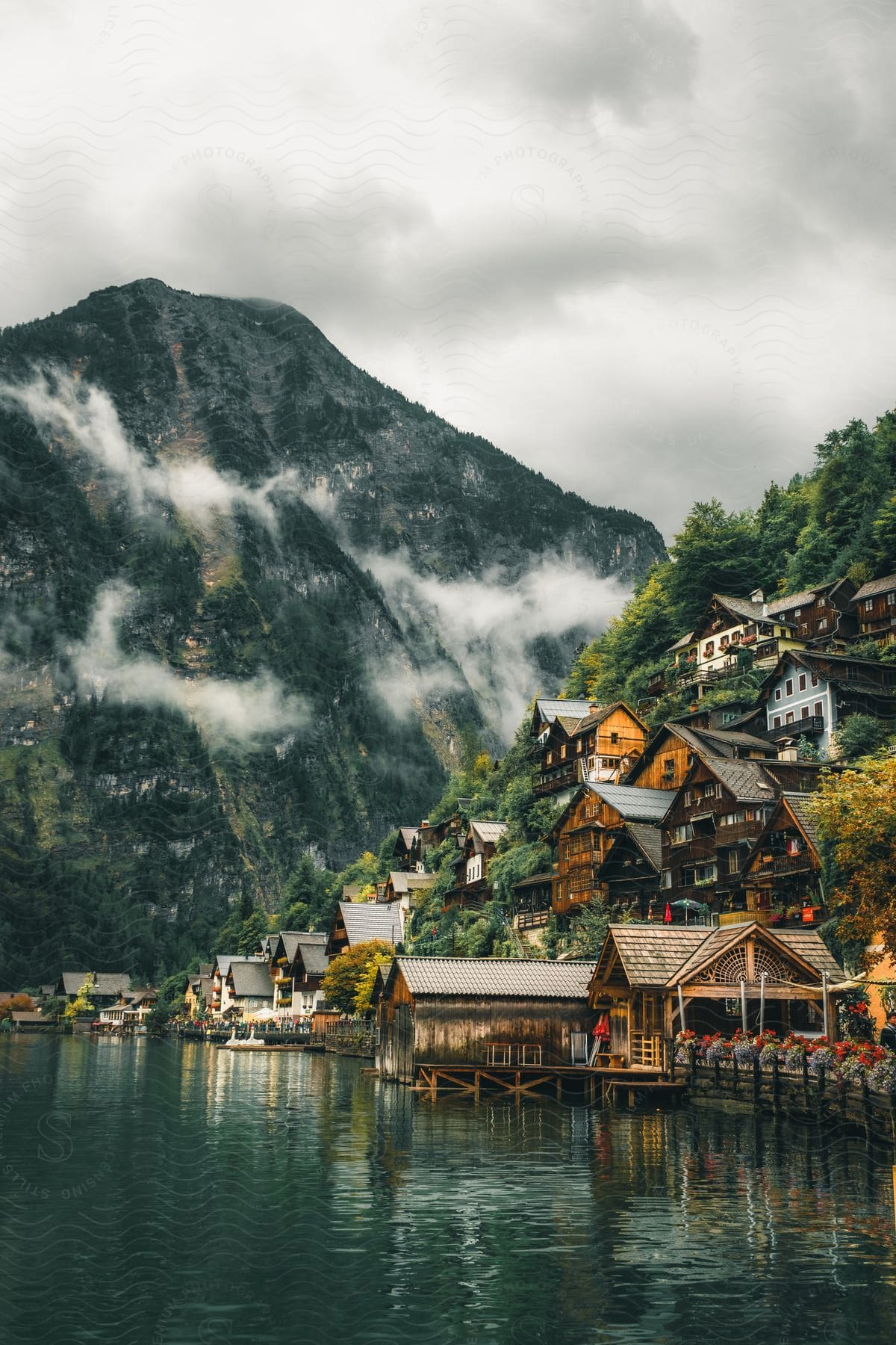 A european village on a mountain next to a lake