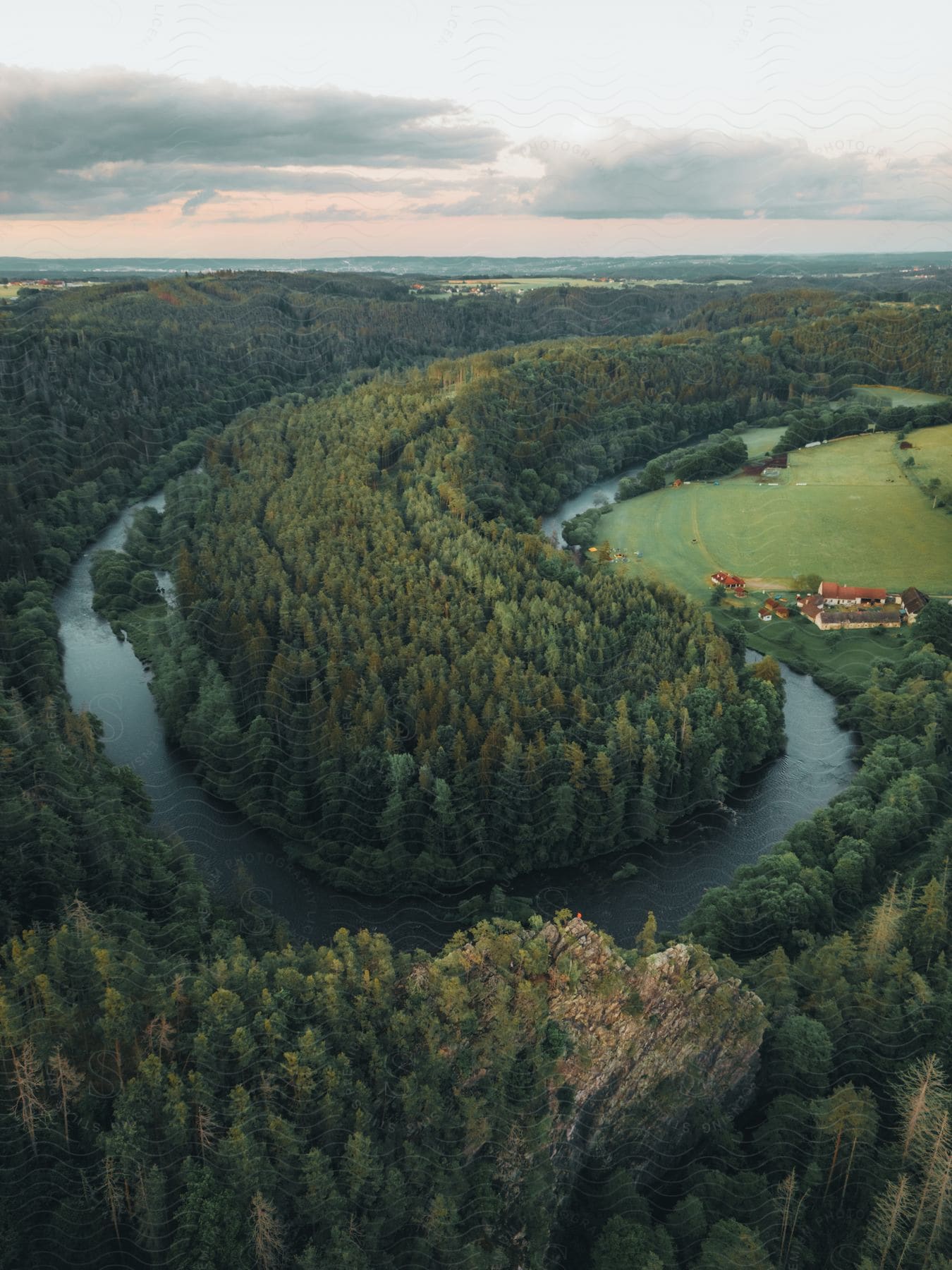 Aerial view of a natural landscape with a river running through a woodland area in the czech republic