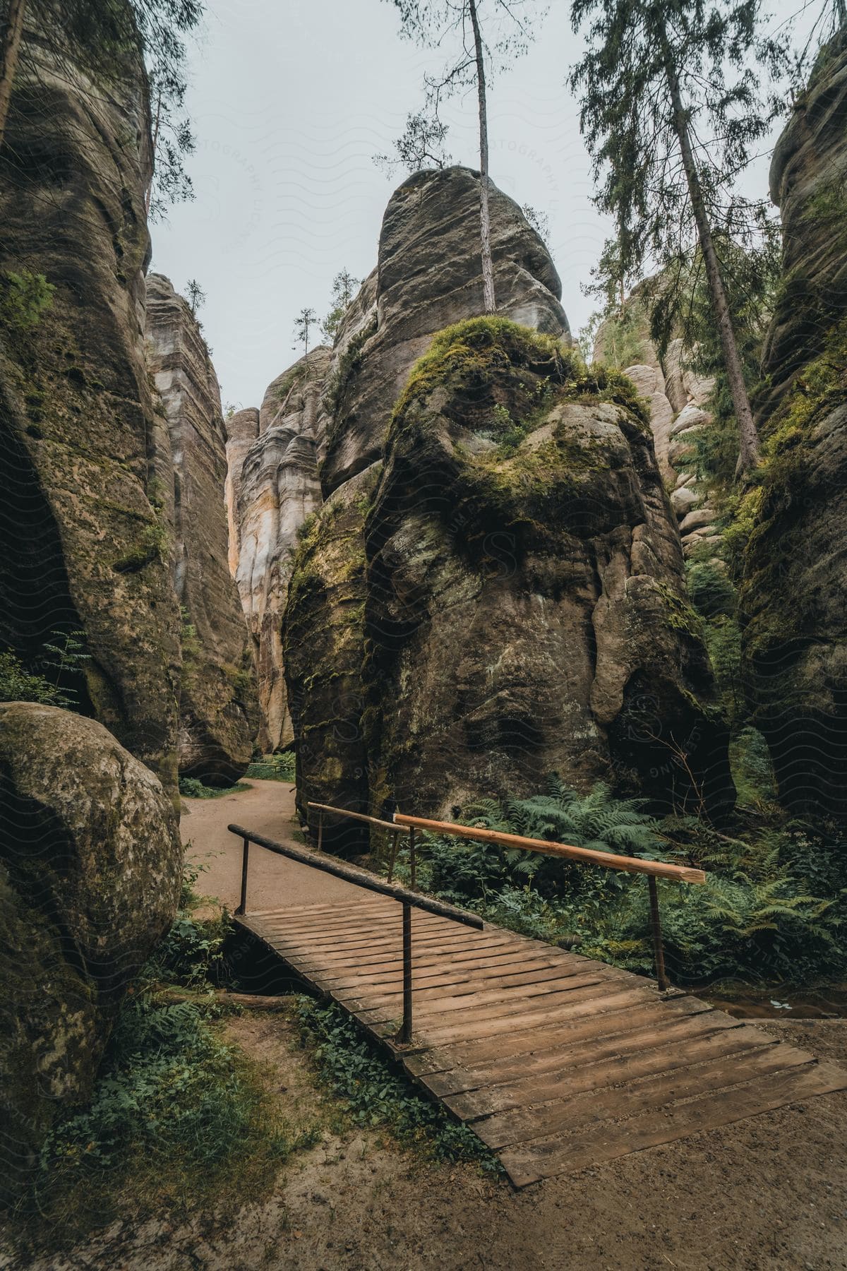 Wooden bridge in a park with big rocks