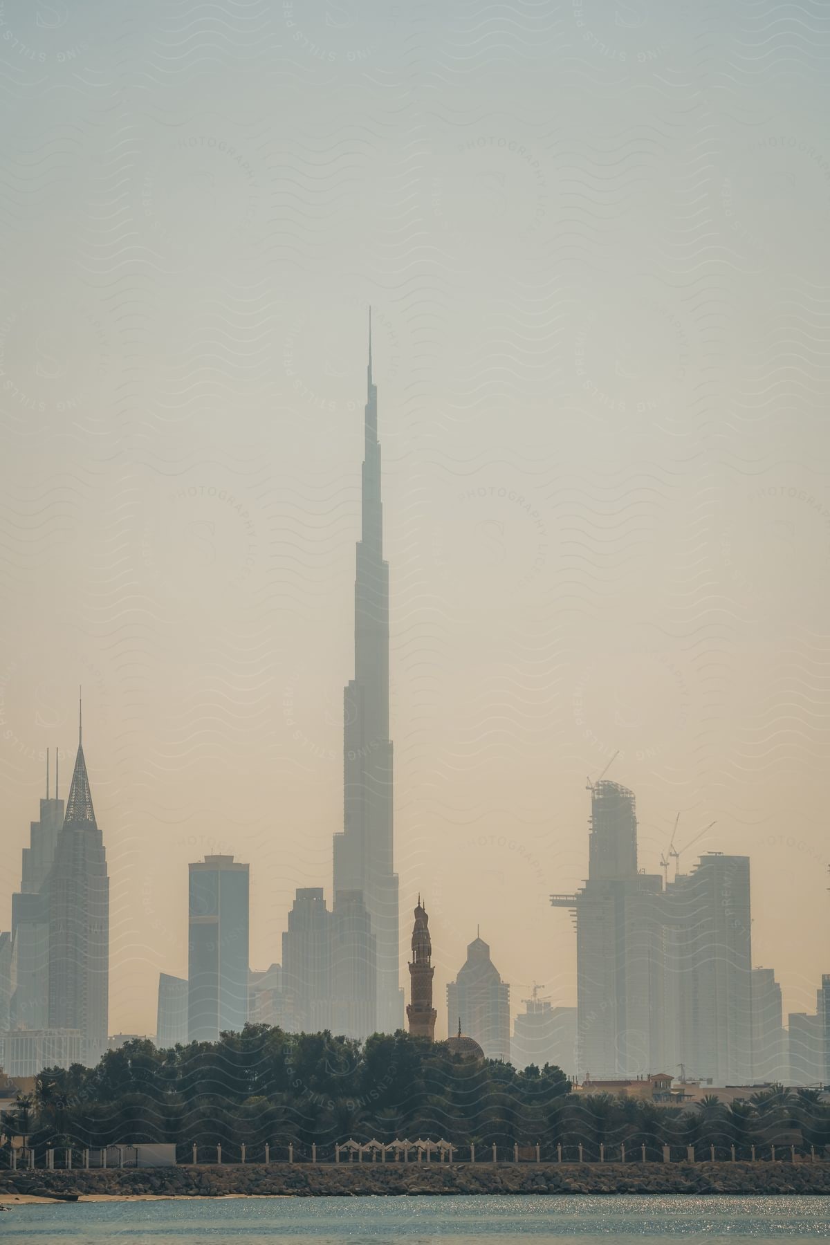 Burj khalifa skyscraper and high rise buildings across the dubai fountain in an urban cityscape