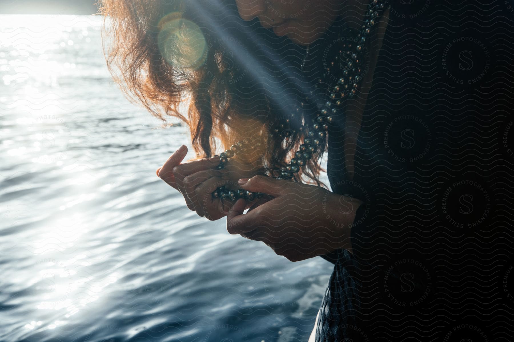 A Polynesian Woman Stands On A Black Sand Beach